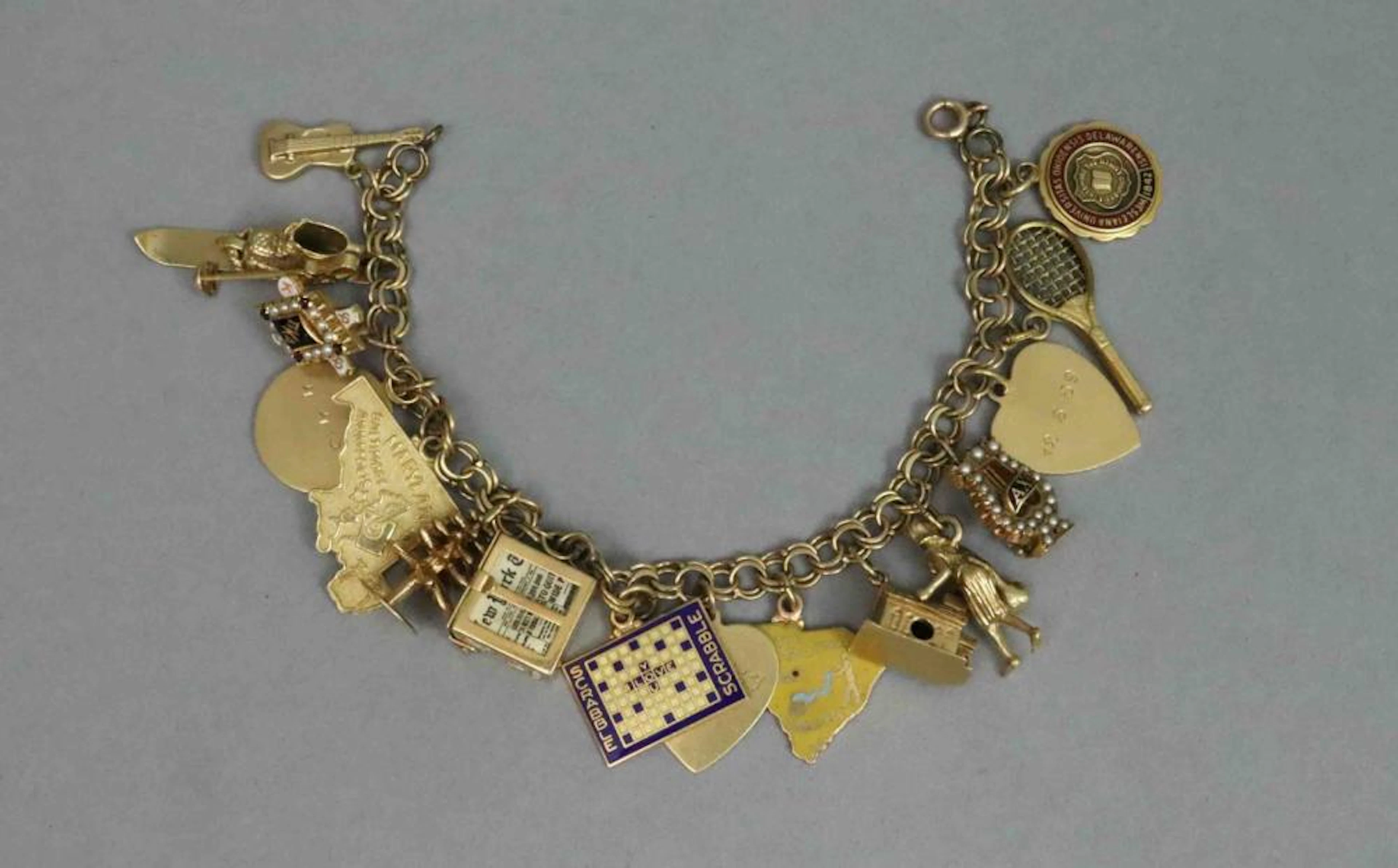 14K CHARM BRACELET WITH (16) 14K CHARMS