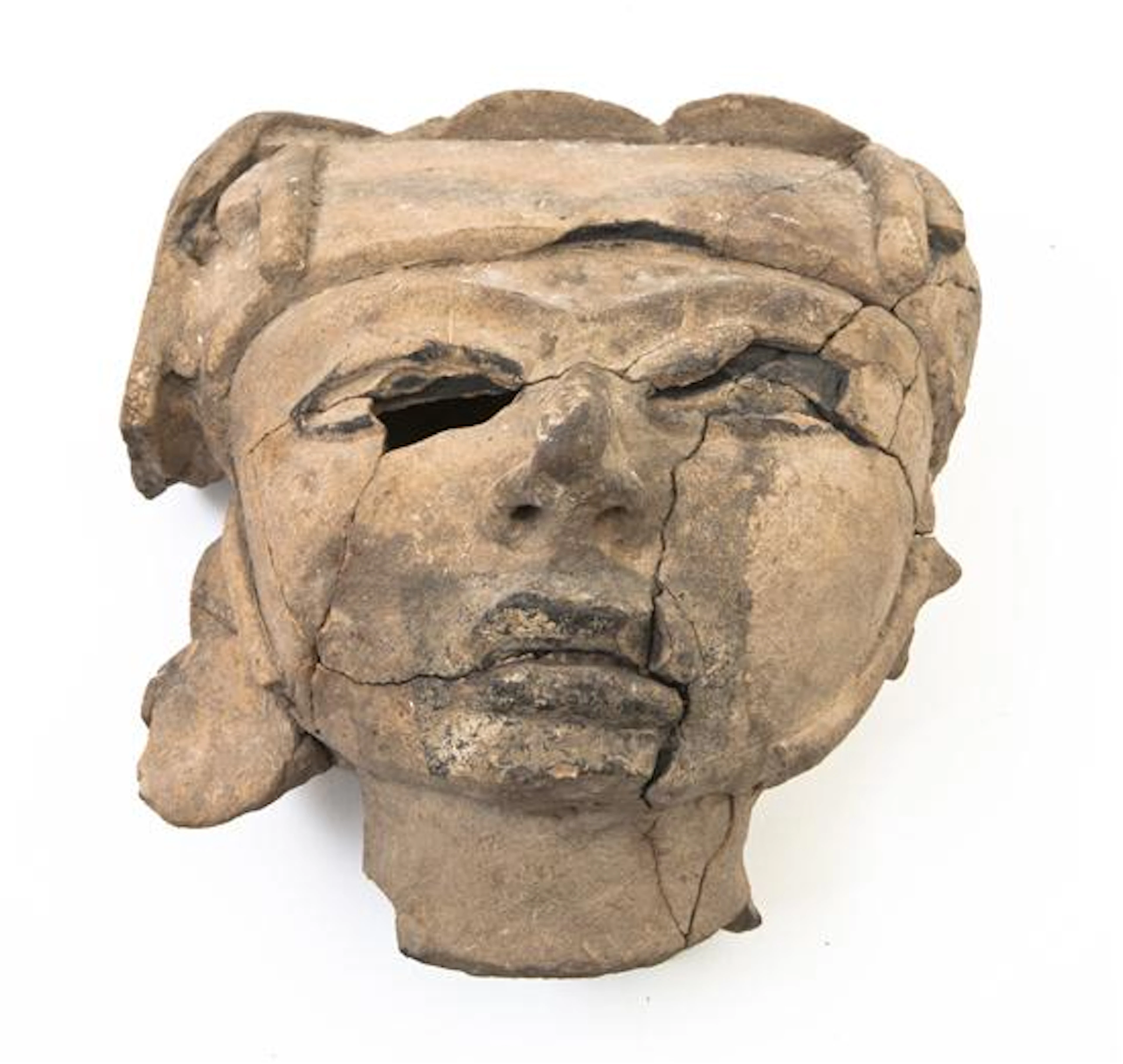 An Olmec Style Pottery Mask, with helmet, previously broken and repaired.