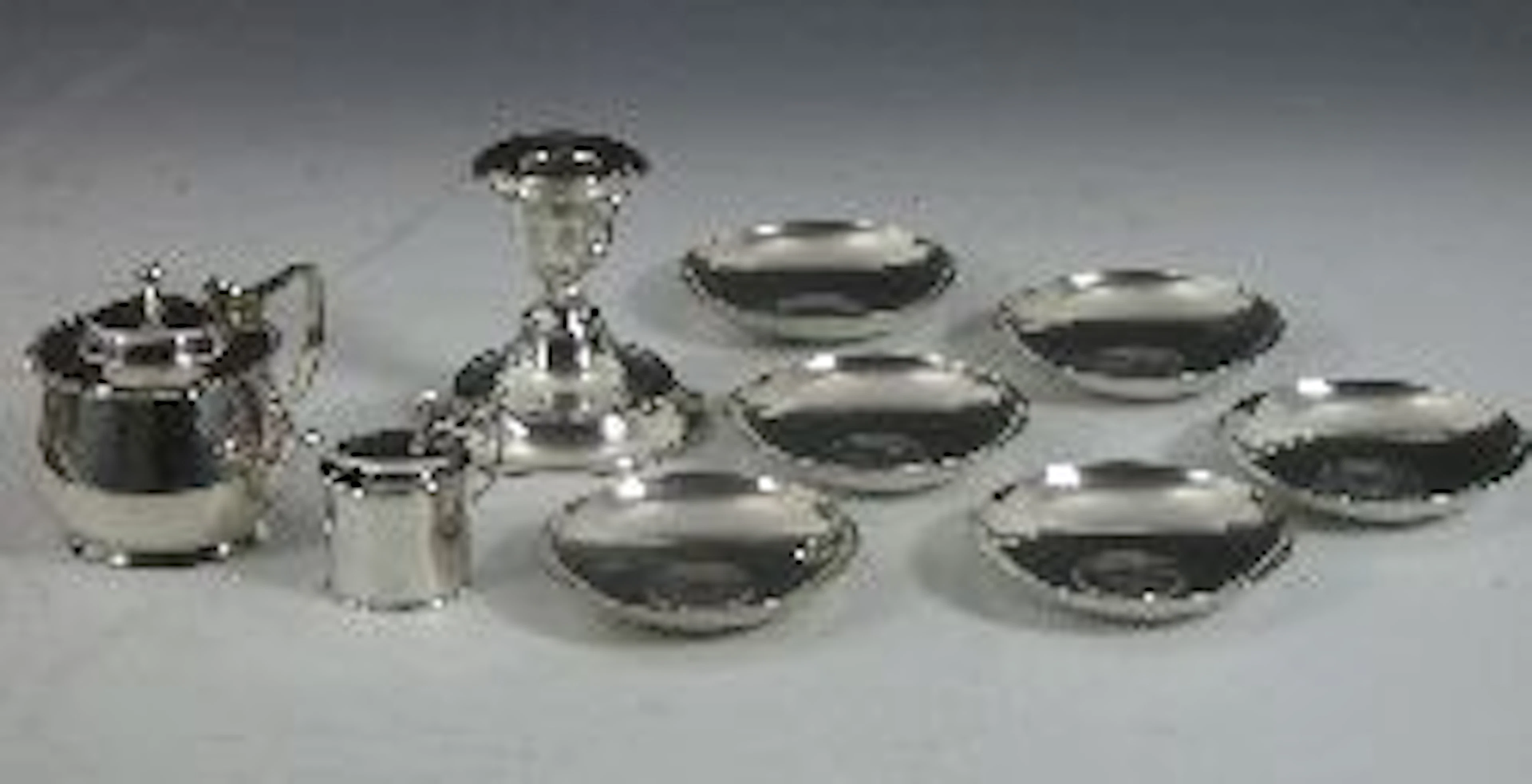 A late Victorian small lidded mustard pot and spoon,, with marks for Sheffield 1893 and 1894, another larger mustard pot, London 1902,...