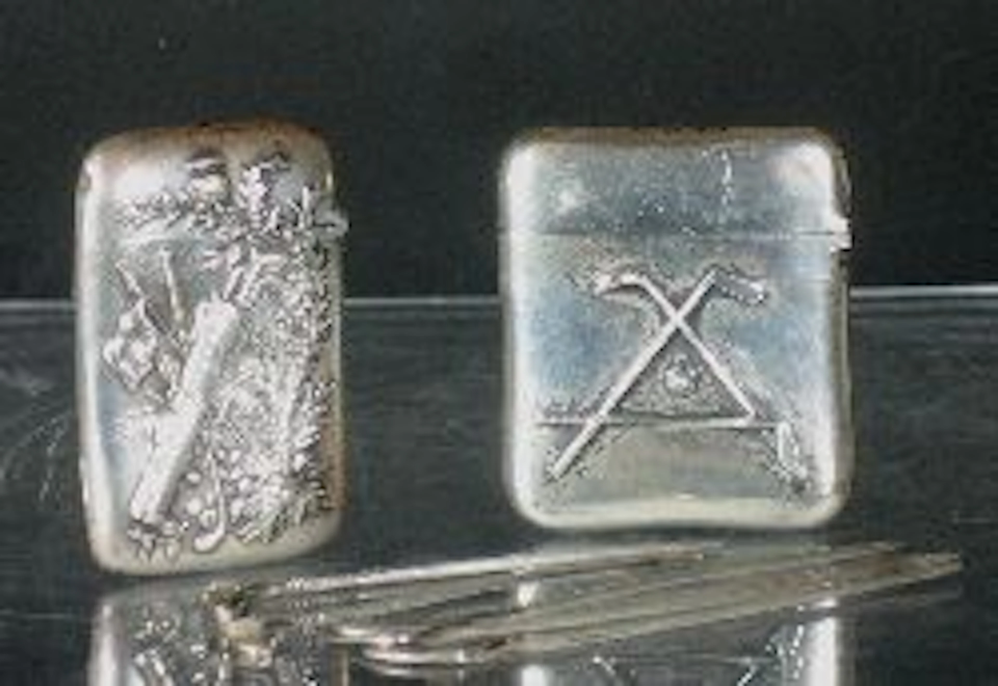 A sterling silver vesta case,, embossed with various golfing emblems and thistles, made by Gorham, circa 1900, 6.1cm; another by the...