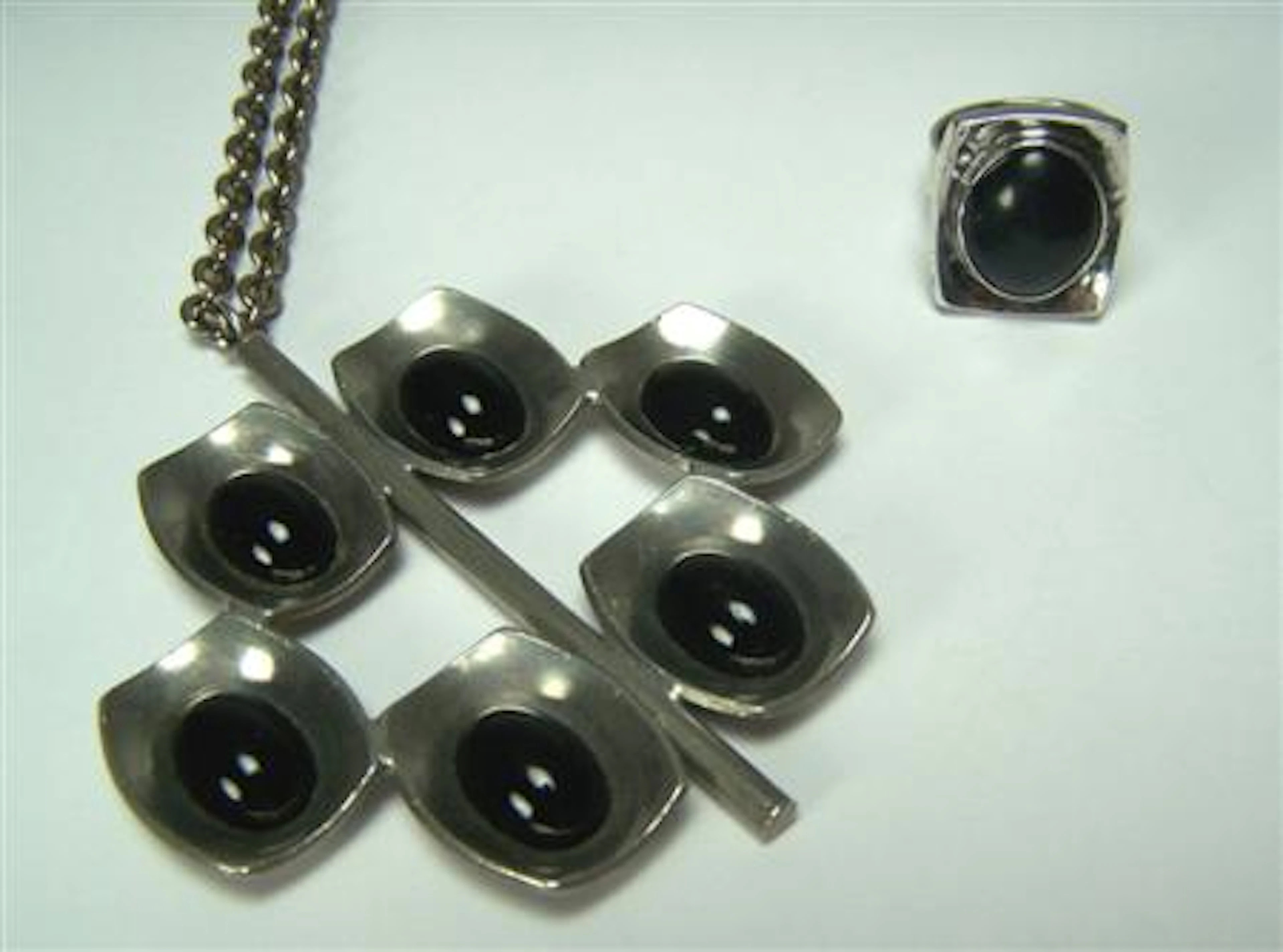 JORGEN JENSEN - a pewter pendant with chain,, composed of curved rectangular panels, each set with an oval cut onyx cabochon, signed...