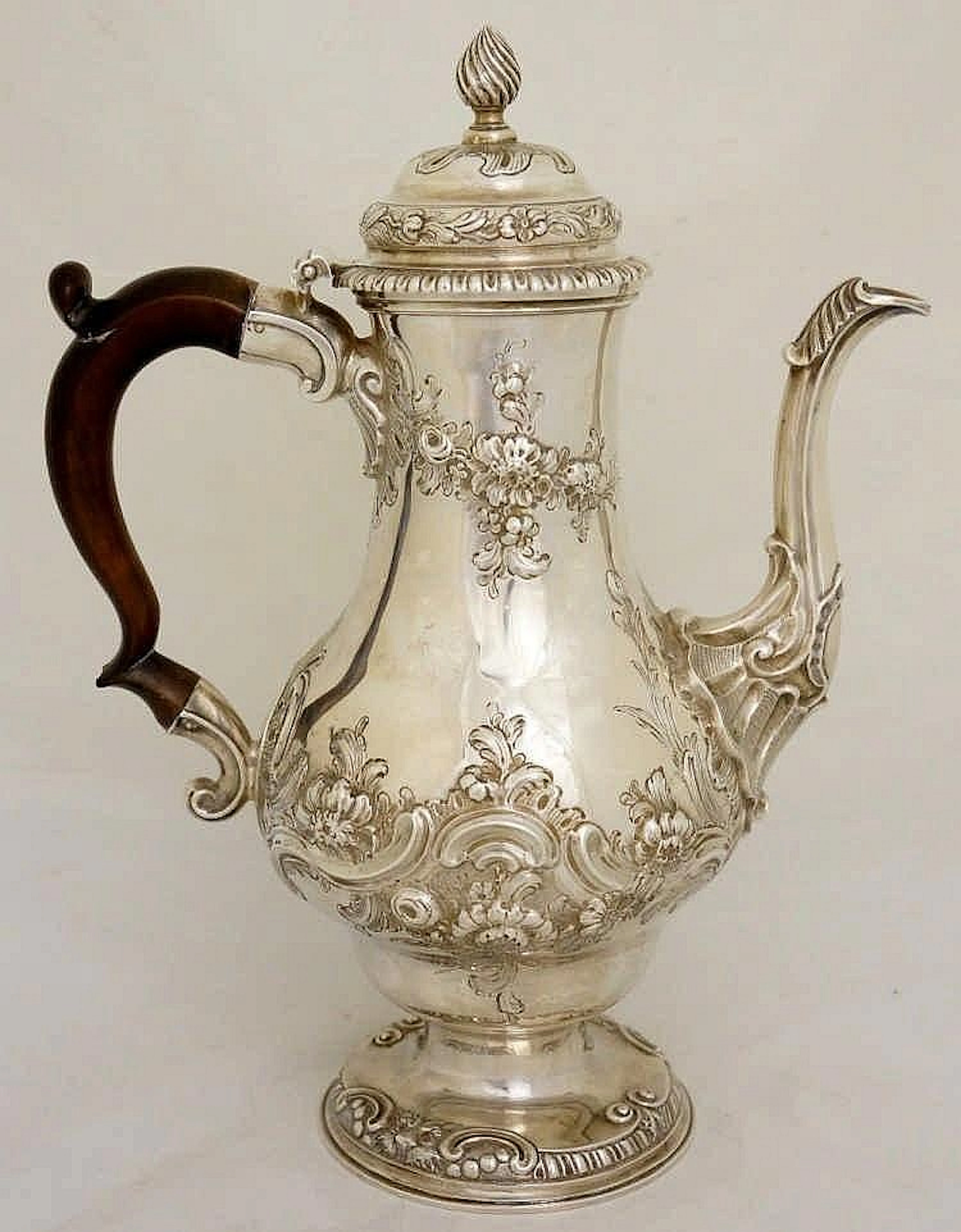 A George II pear-shaped coffee pot, the hinged lid with wrythen fluted fini