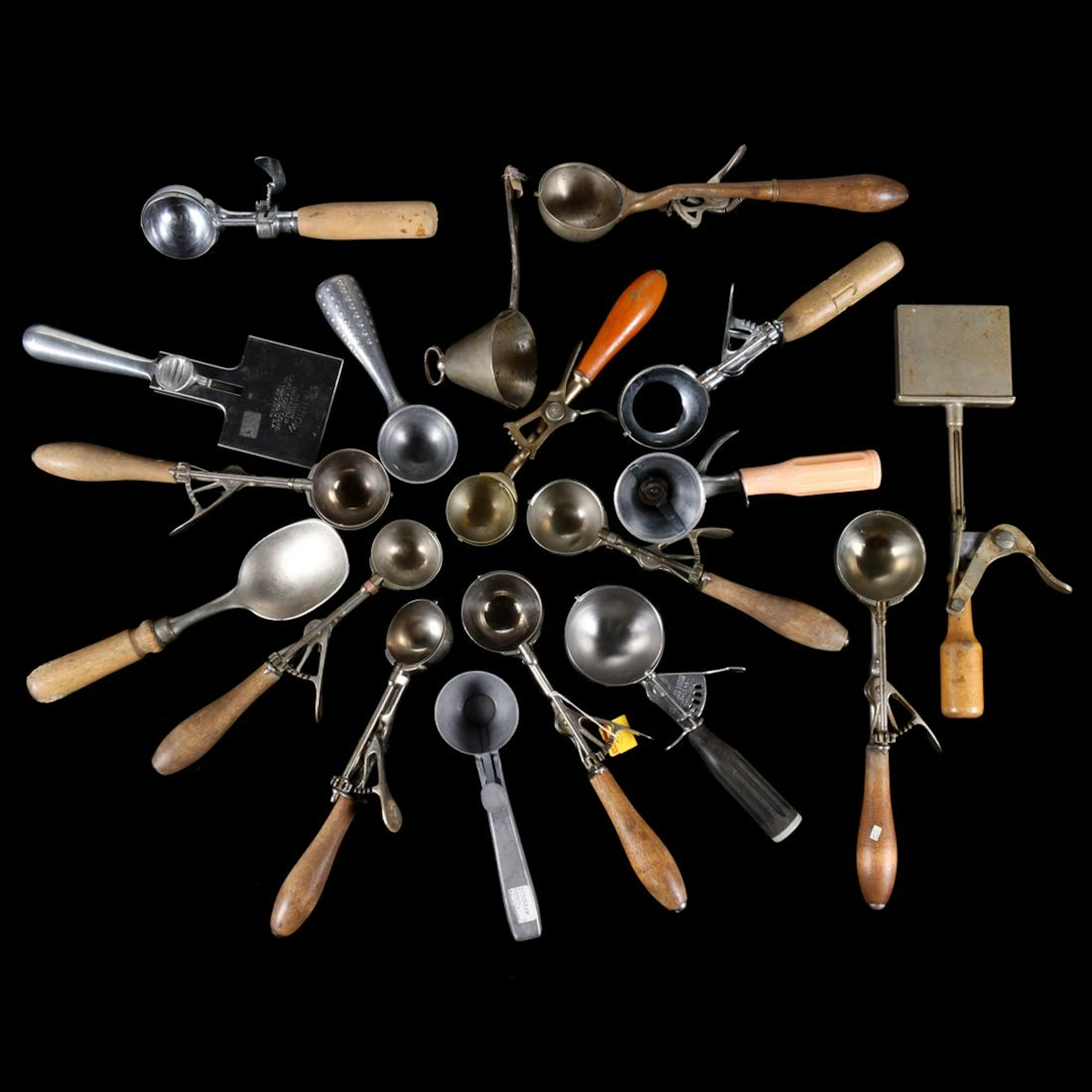 A COLLECTION OF SIXTEEN ANTIQUE ICE CREAM SCOOPS