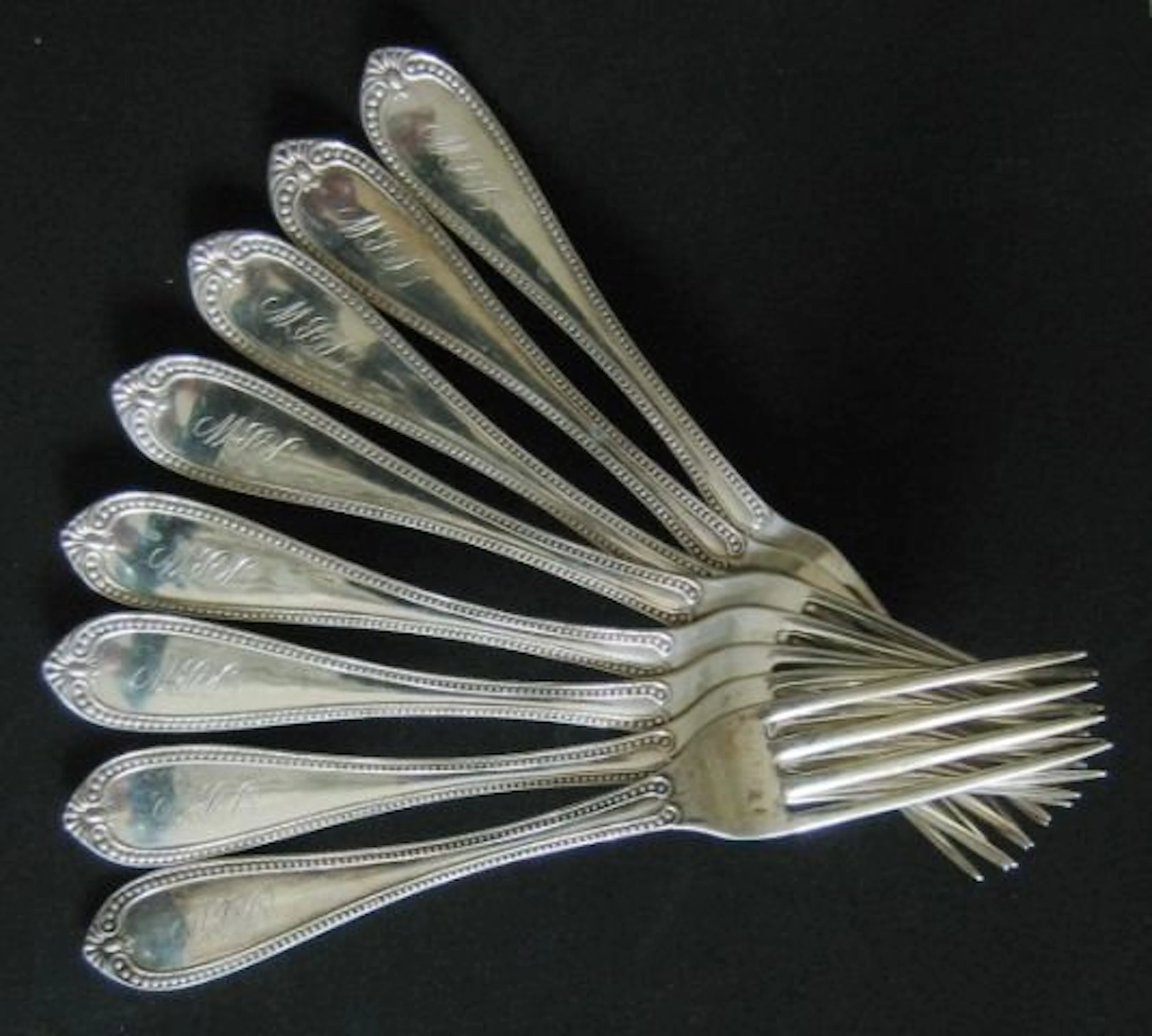 Eight coin silver salad forks