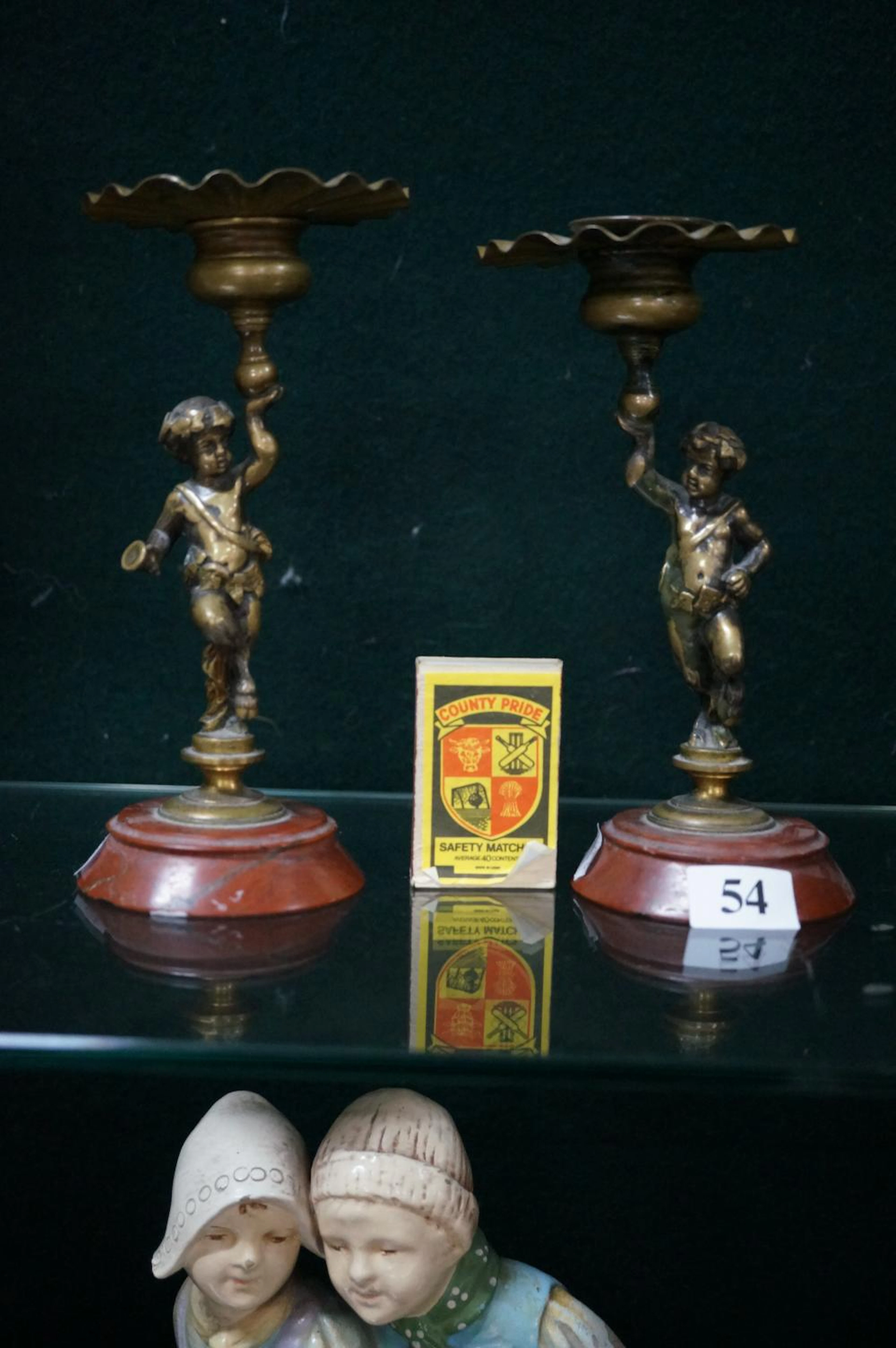 PR C19TH BRASS FIGURED CANDELSTICKS OM MARBLE BASES, 17 CM HIGH