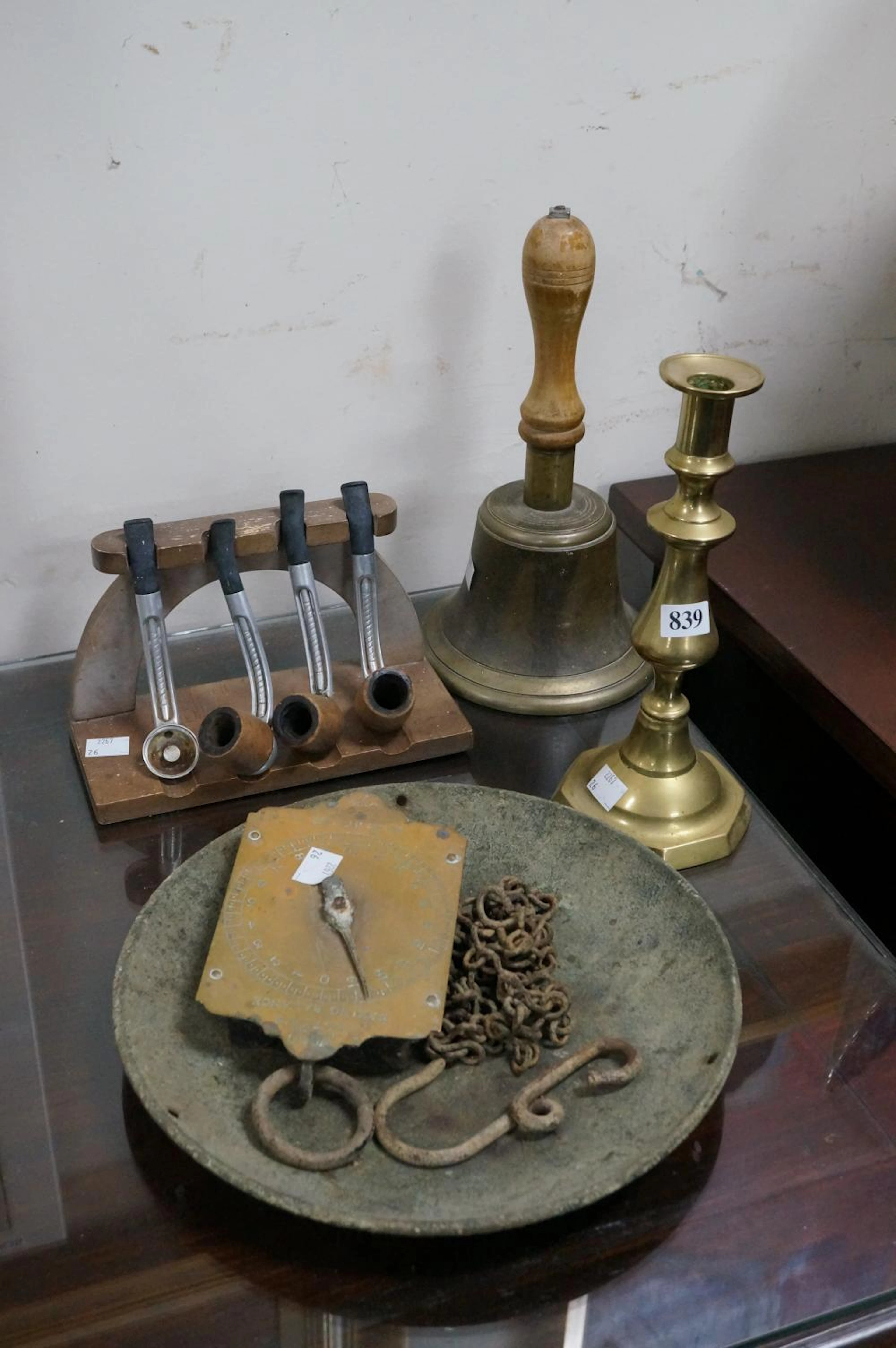 Brass bell, hanging scales, candelstick & pipes