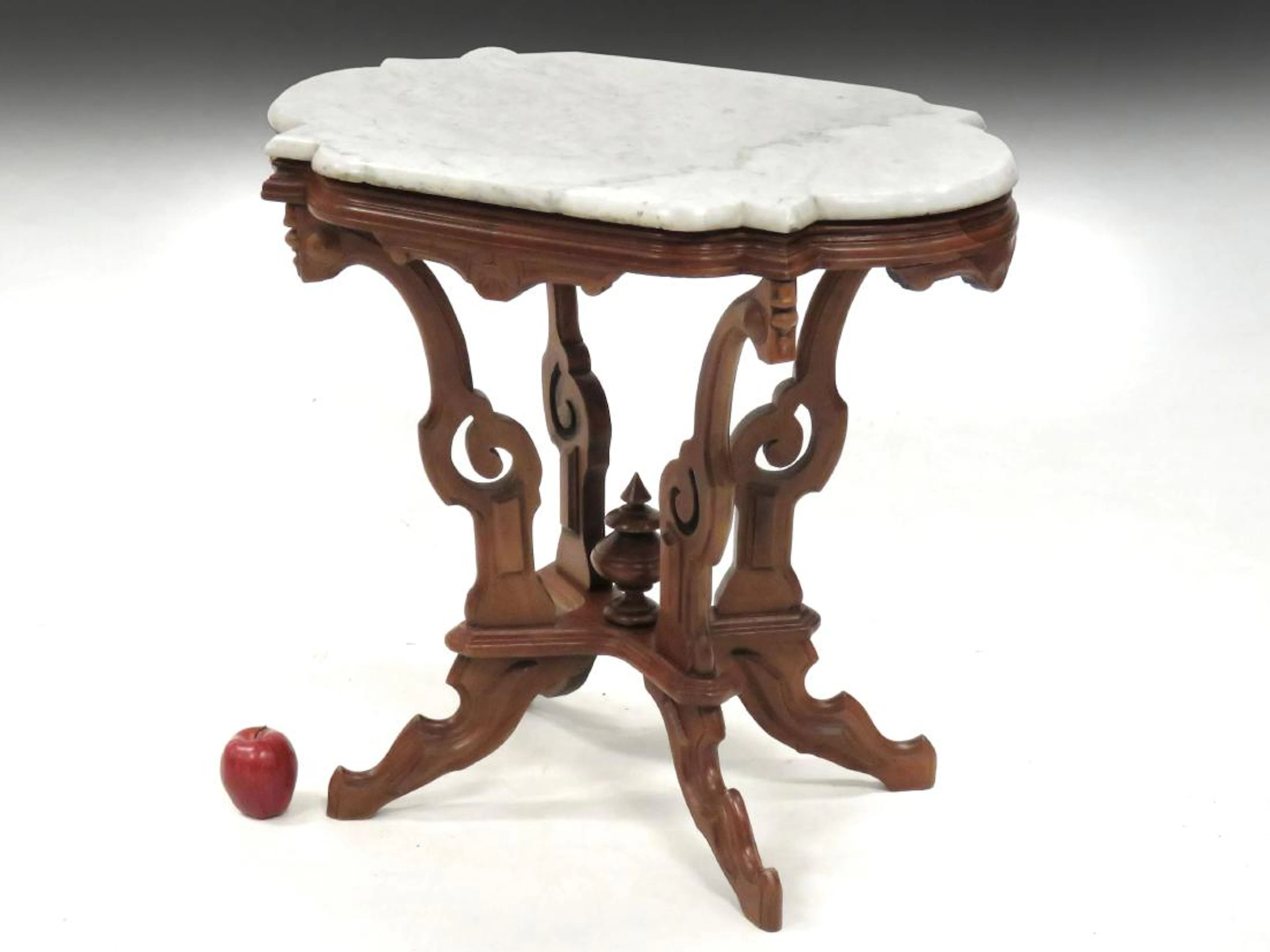Victorian carved walnut stand with shape marble top,
