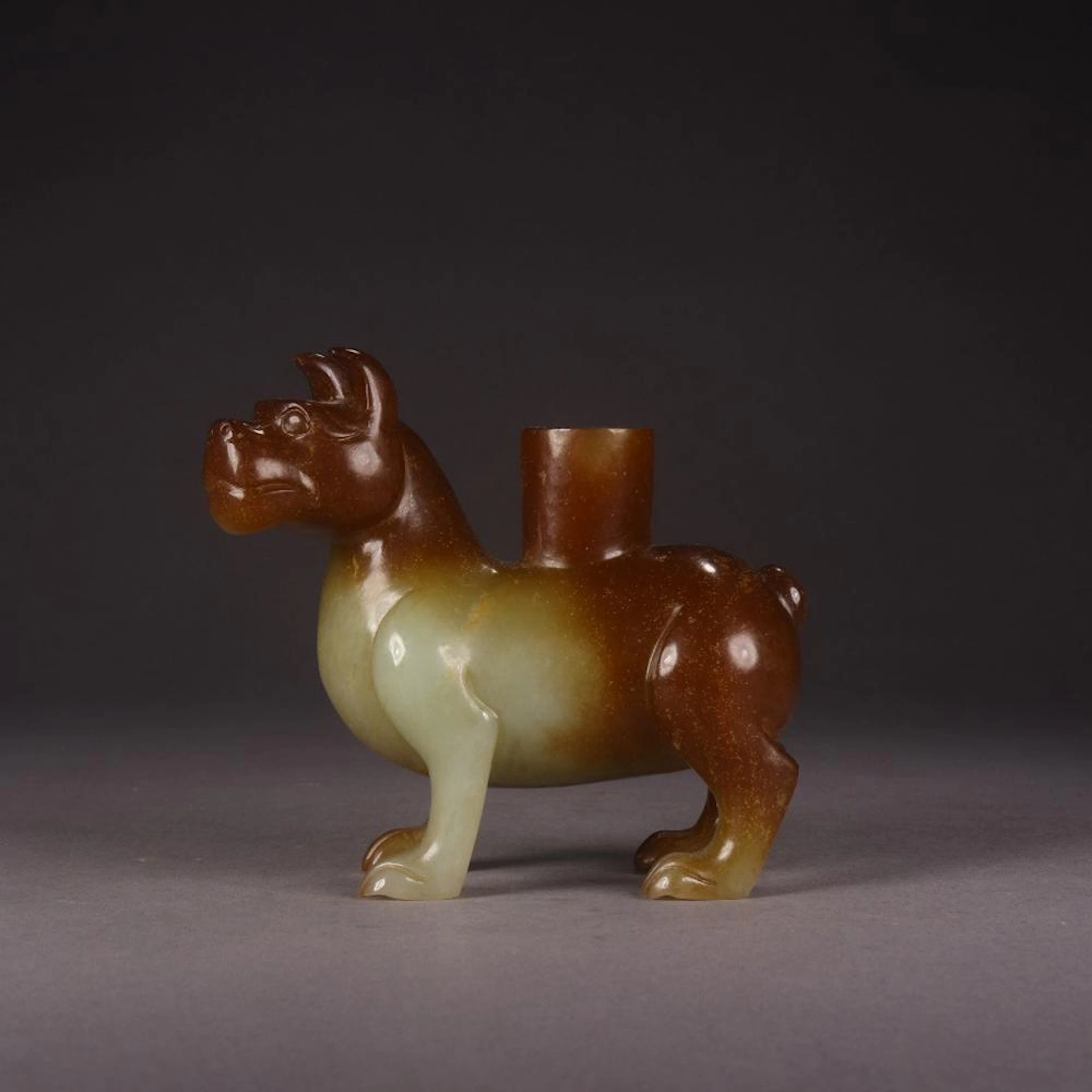 A CHINESE HETIAN JADE CARVED BEAST SHAPED CANDLESTICK