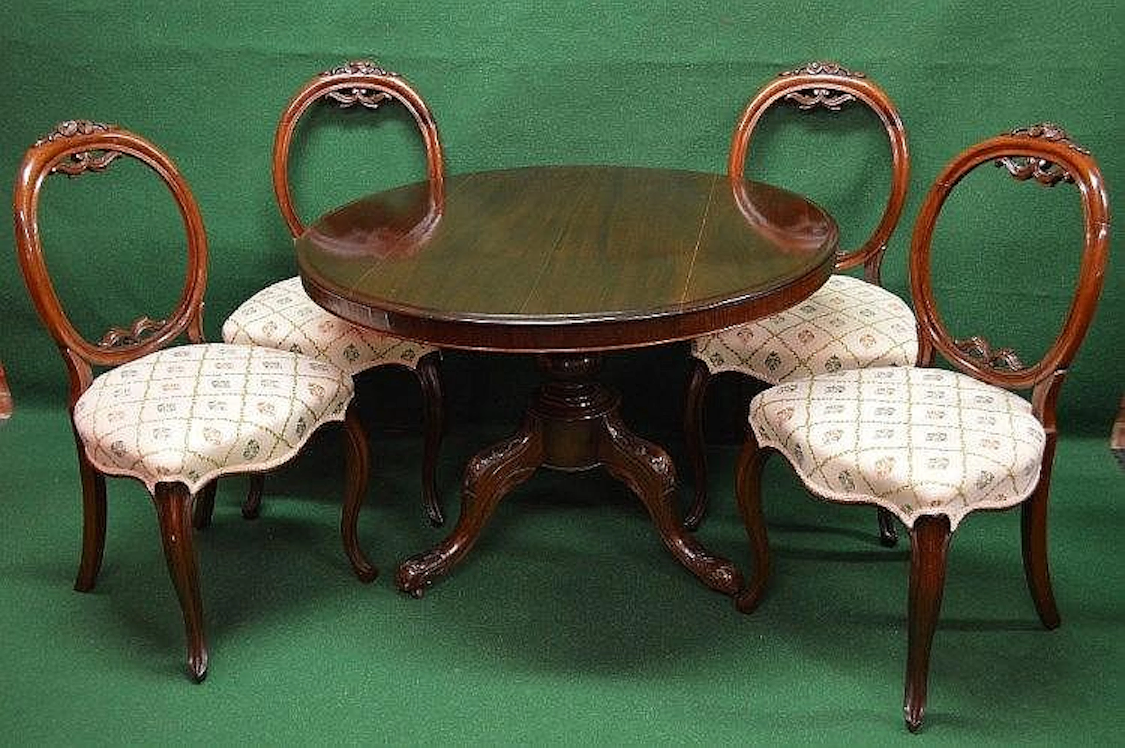A set of four hoop back dining chairs with carved frames...