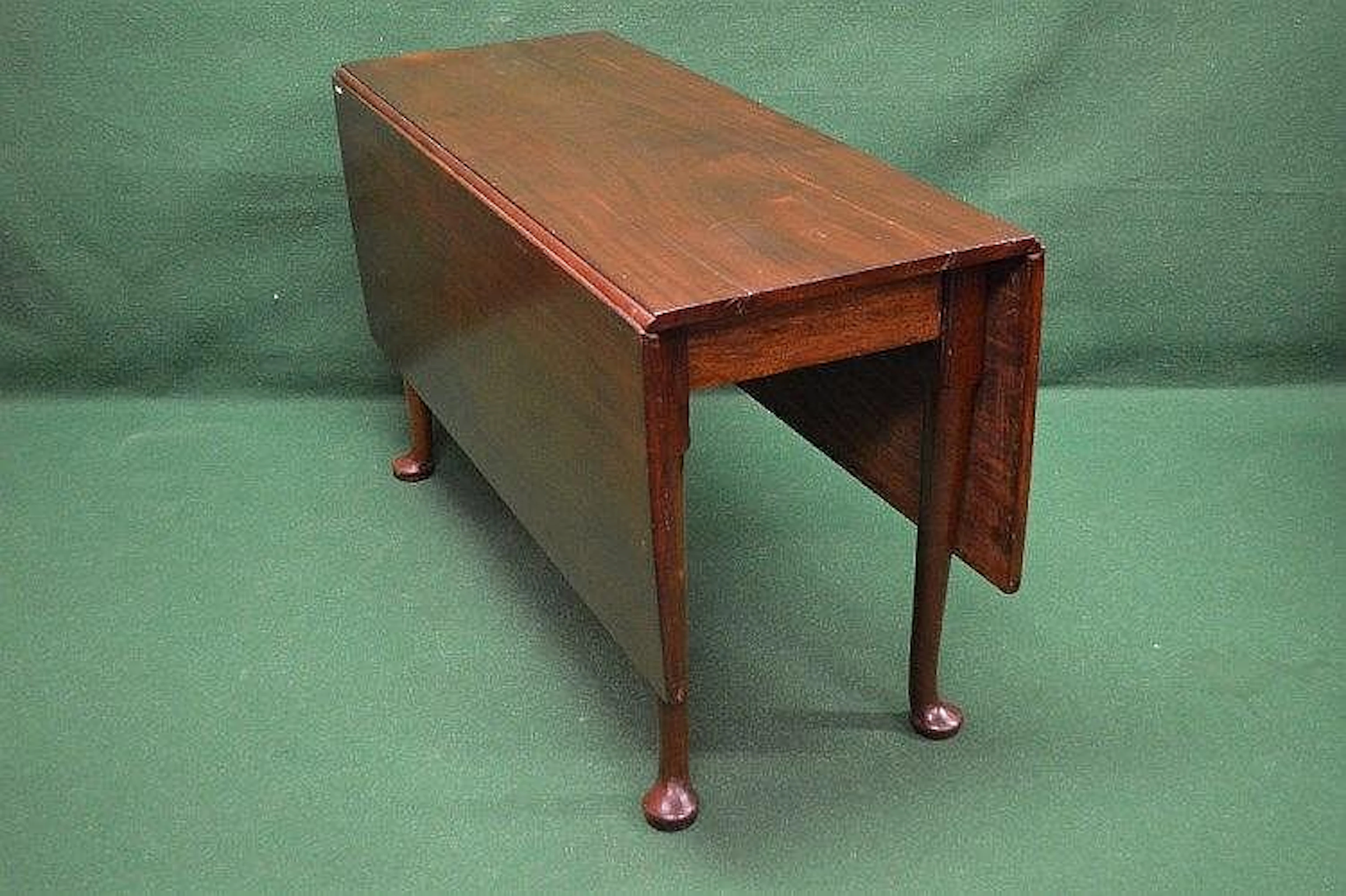 A Georgian Cuban mahogany drop leaf dining table standing...