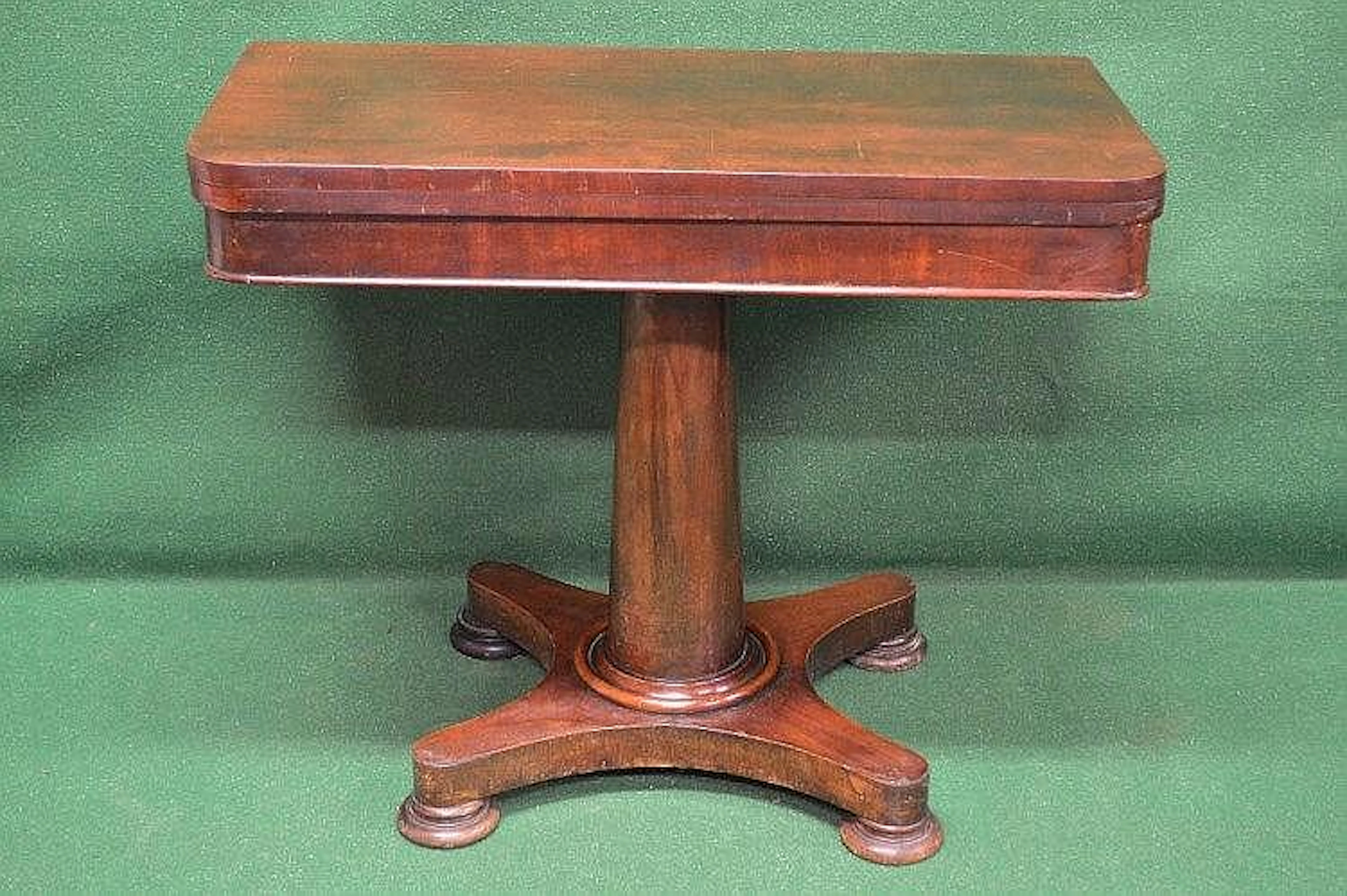Mahogany fold over card table with circular green baize...