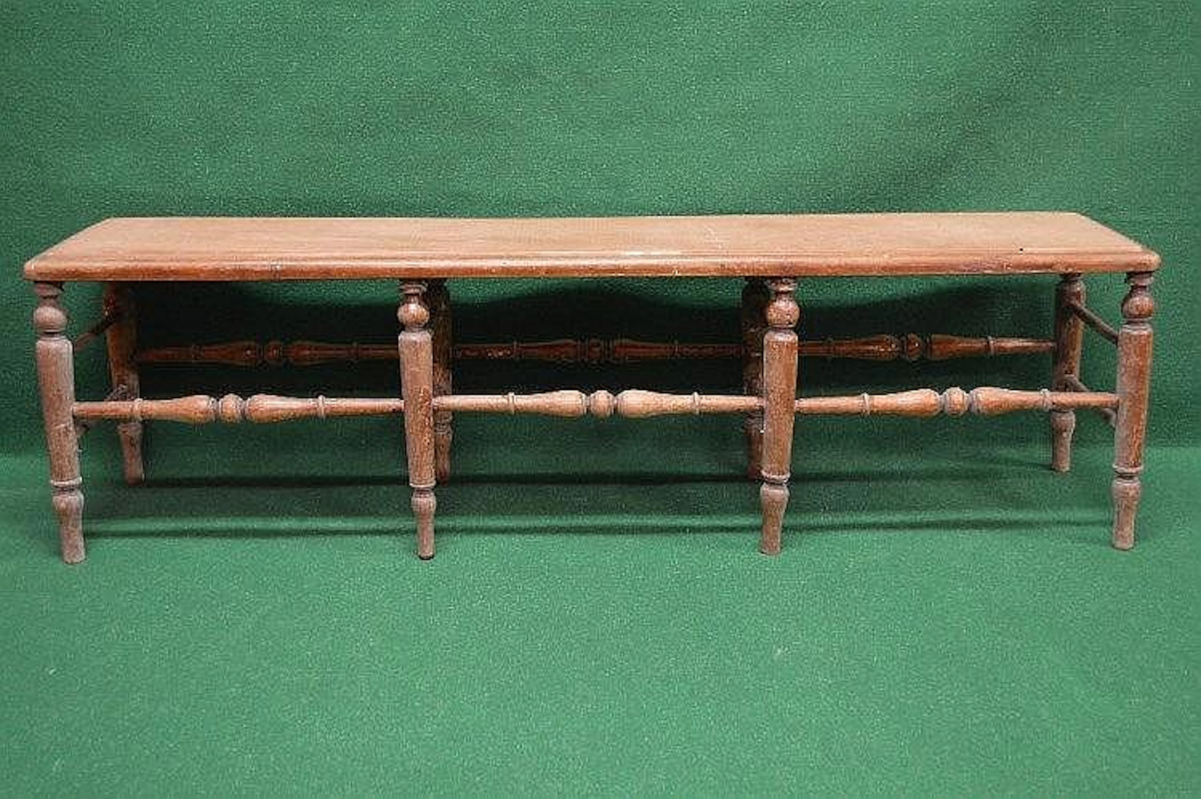 Beech framed long stool having solid seat and supported...