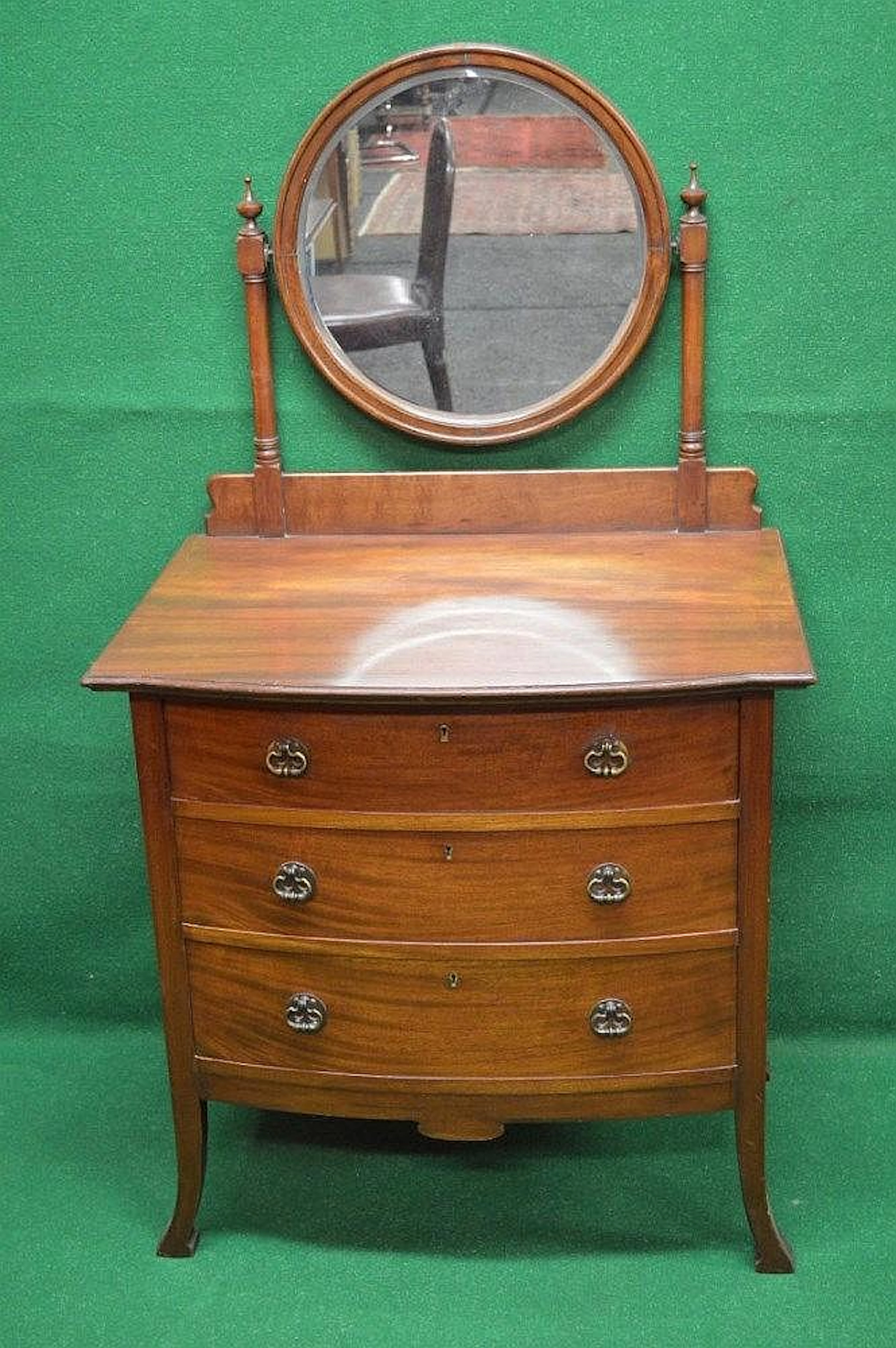 Mahogany bow fronted dressing chest with circular tilting...