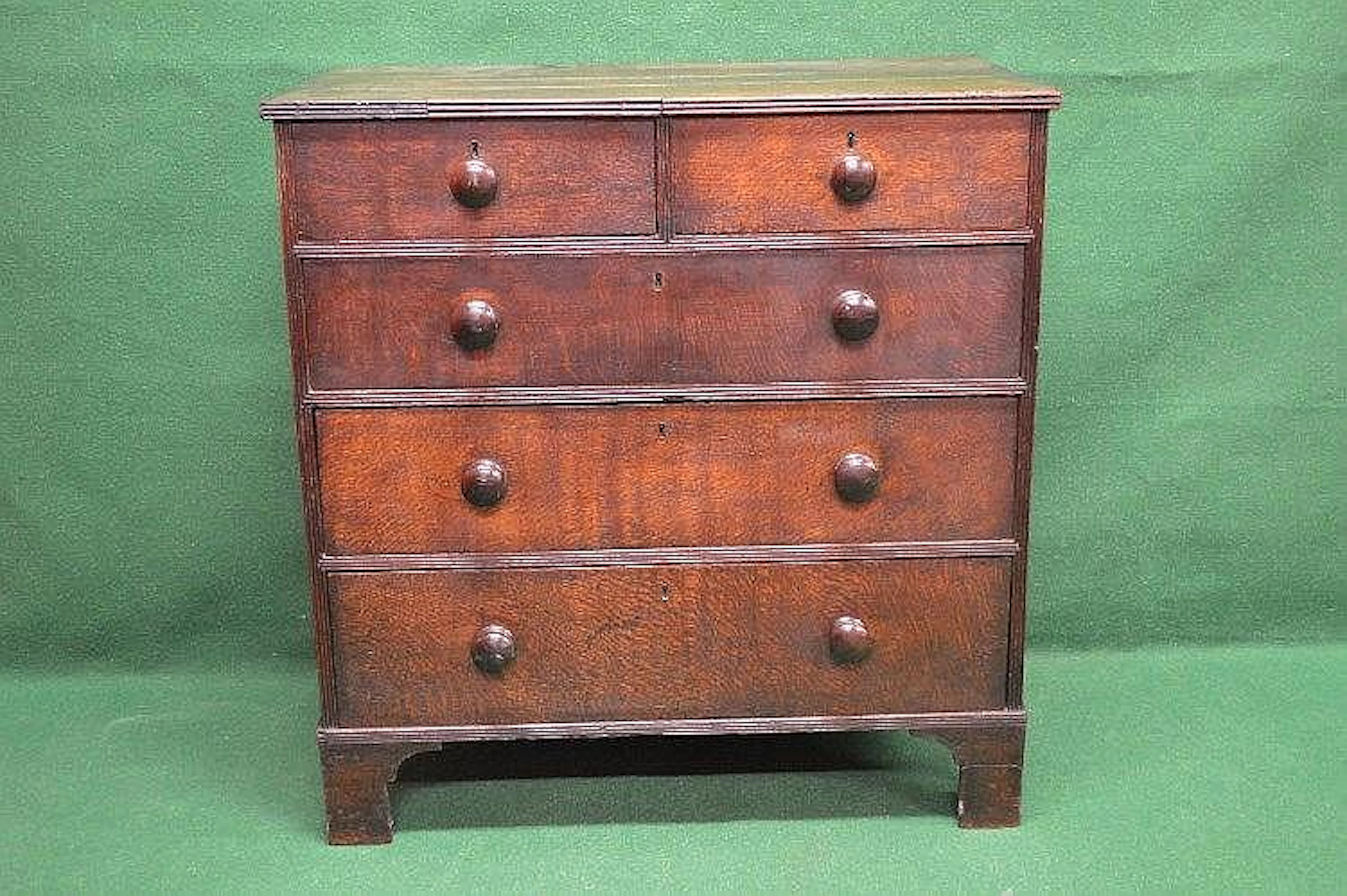 An 18th century oak chest of five drawers having two...