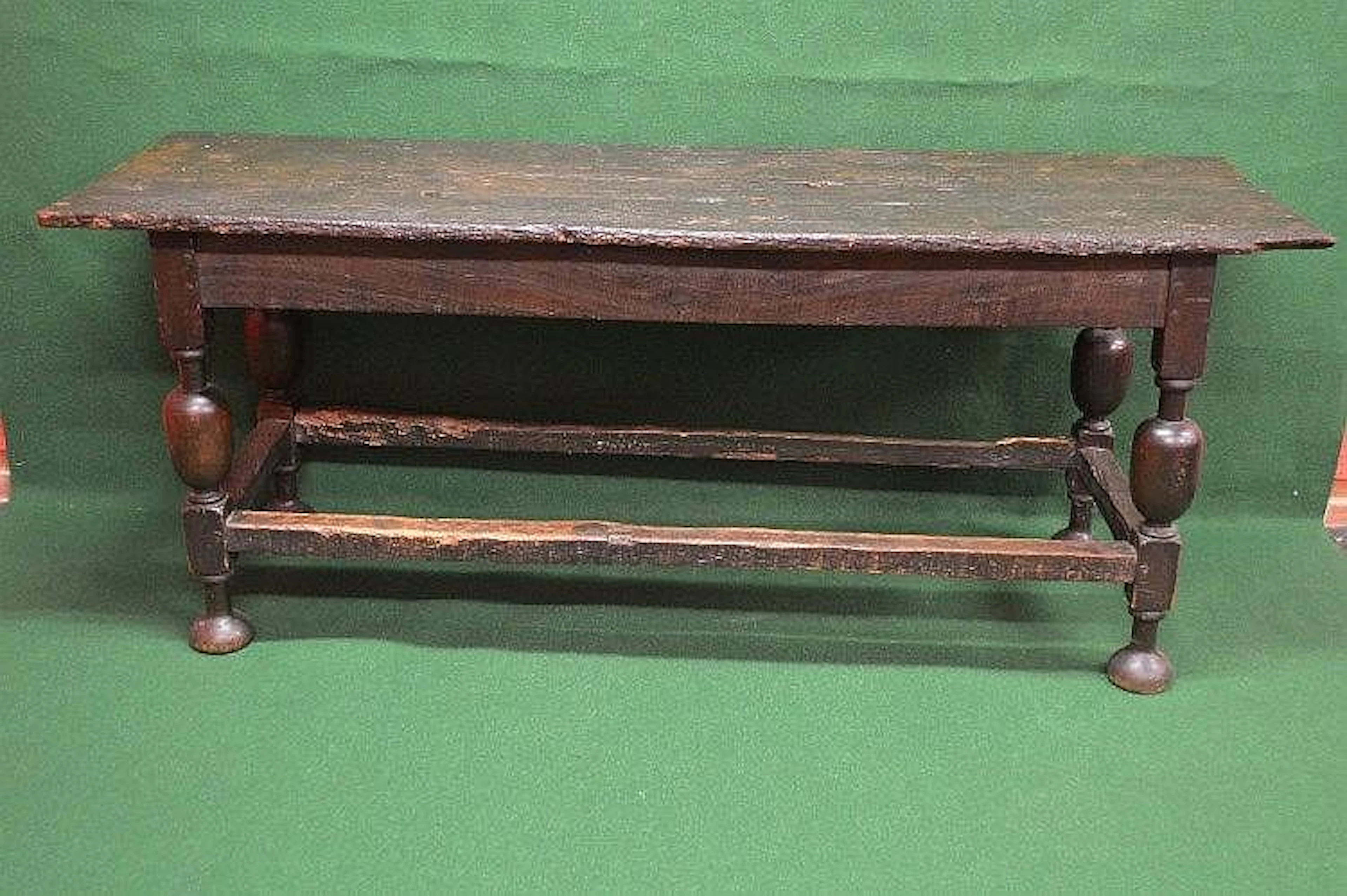 A period oak refectory table having three plank top...