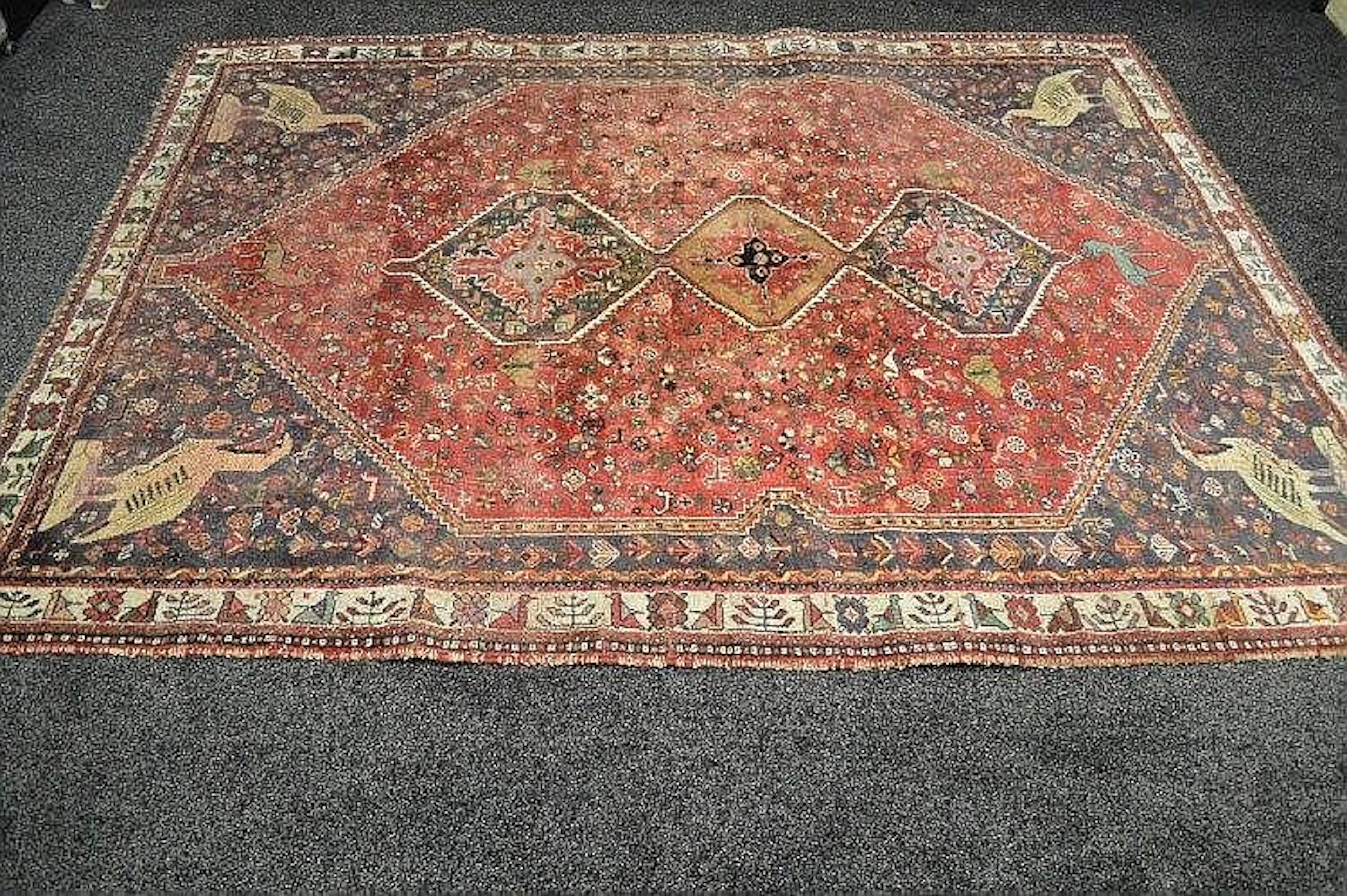 Red ground rug with green