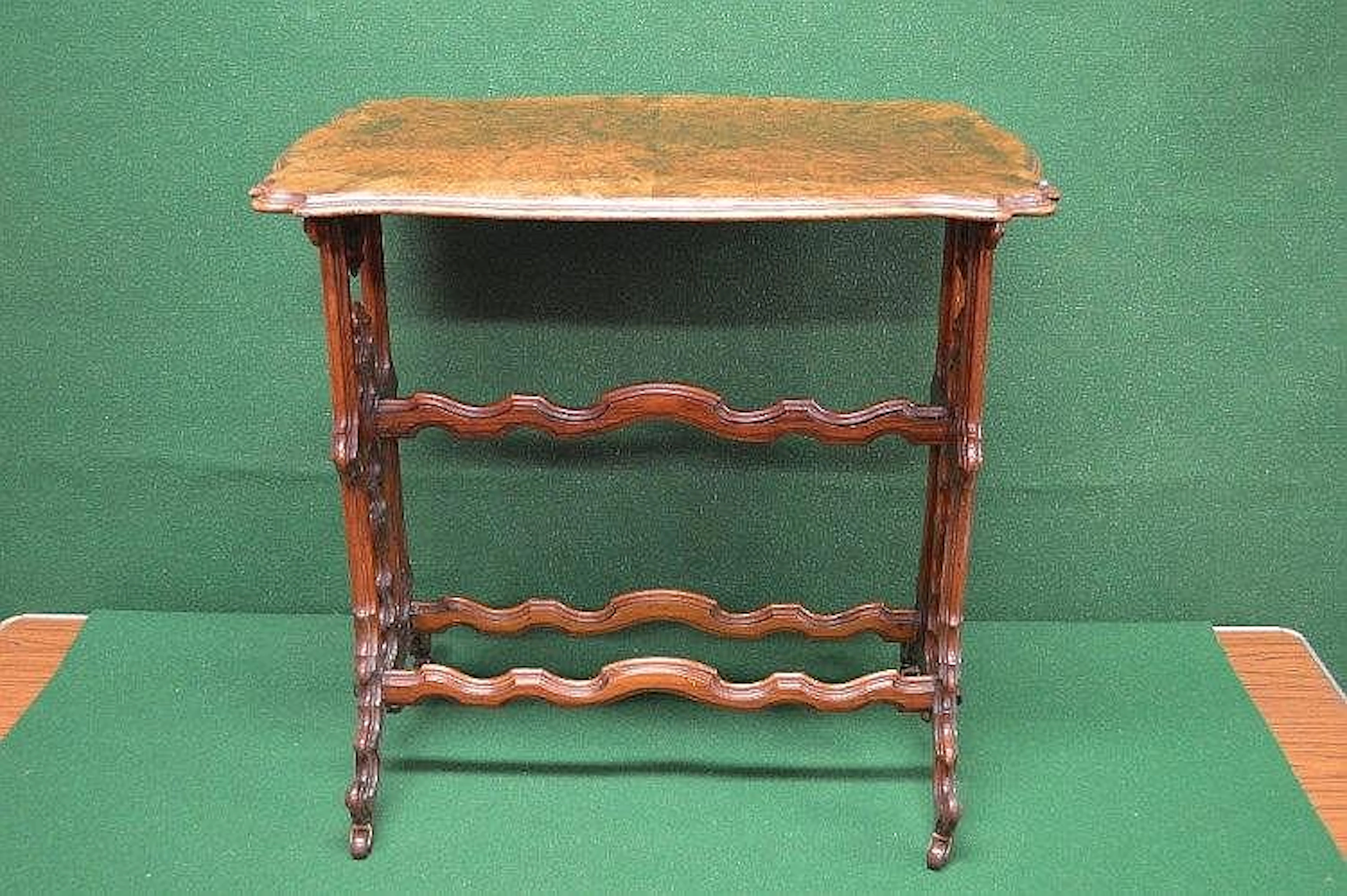 Shaped walnut occasional table supported on two Gothic...