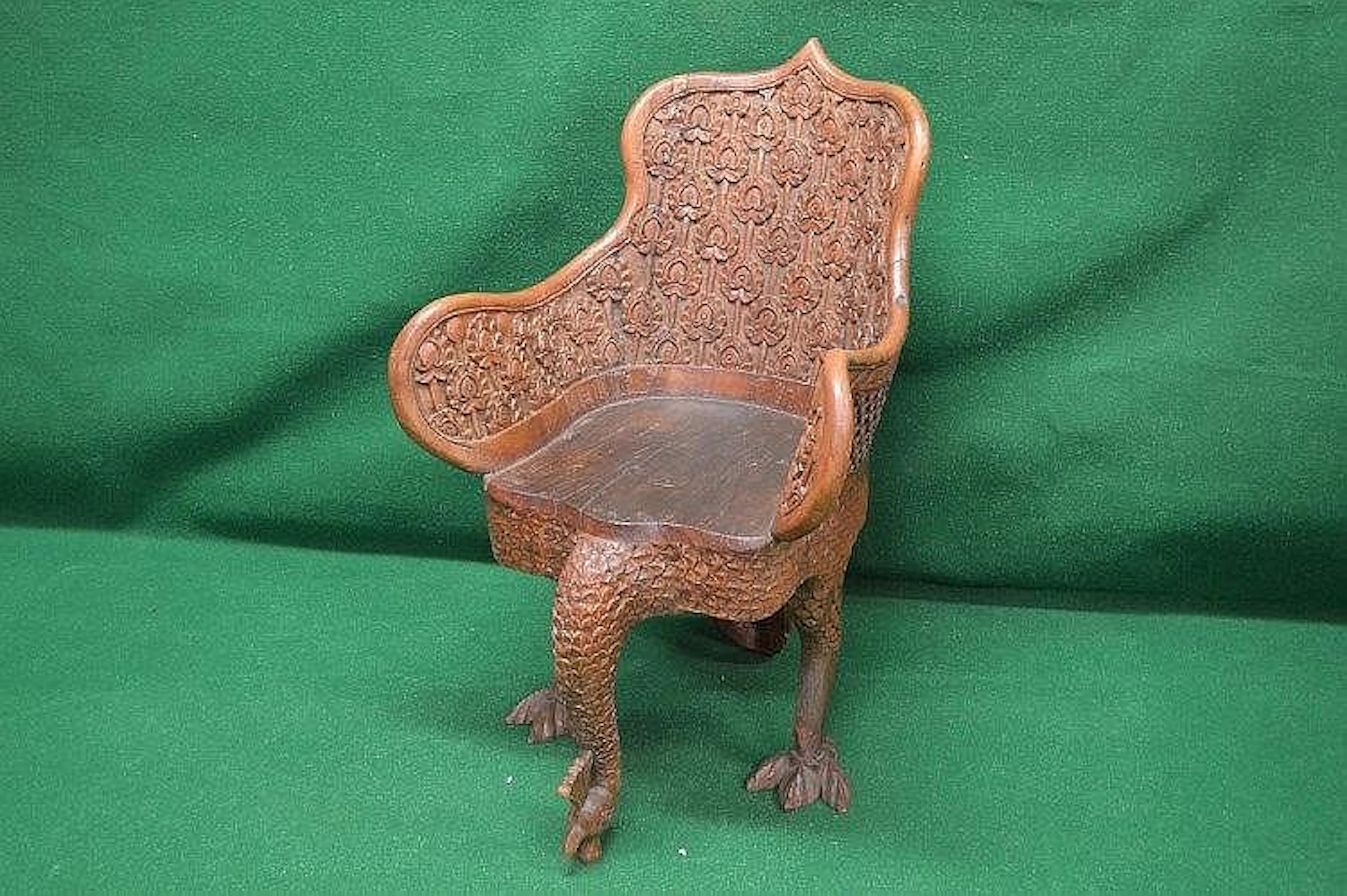 Hardwood carved tub chair in the form of a peacock the...
