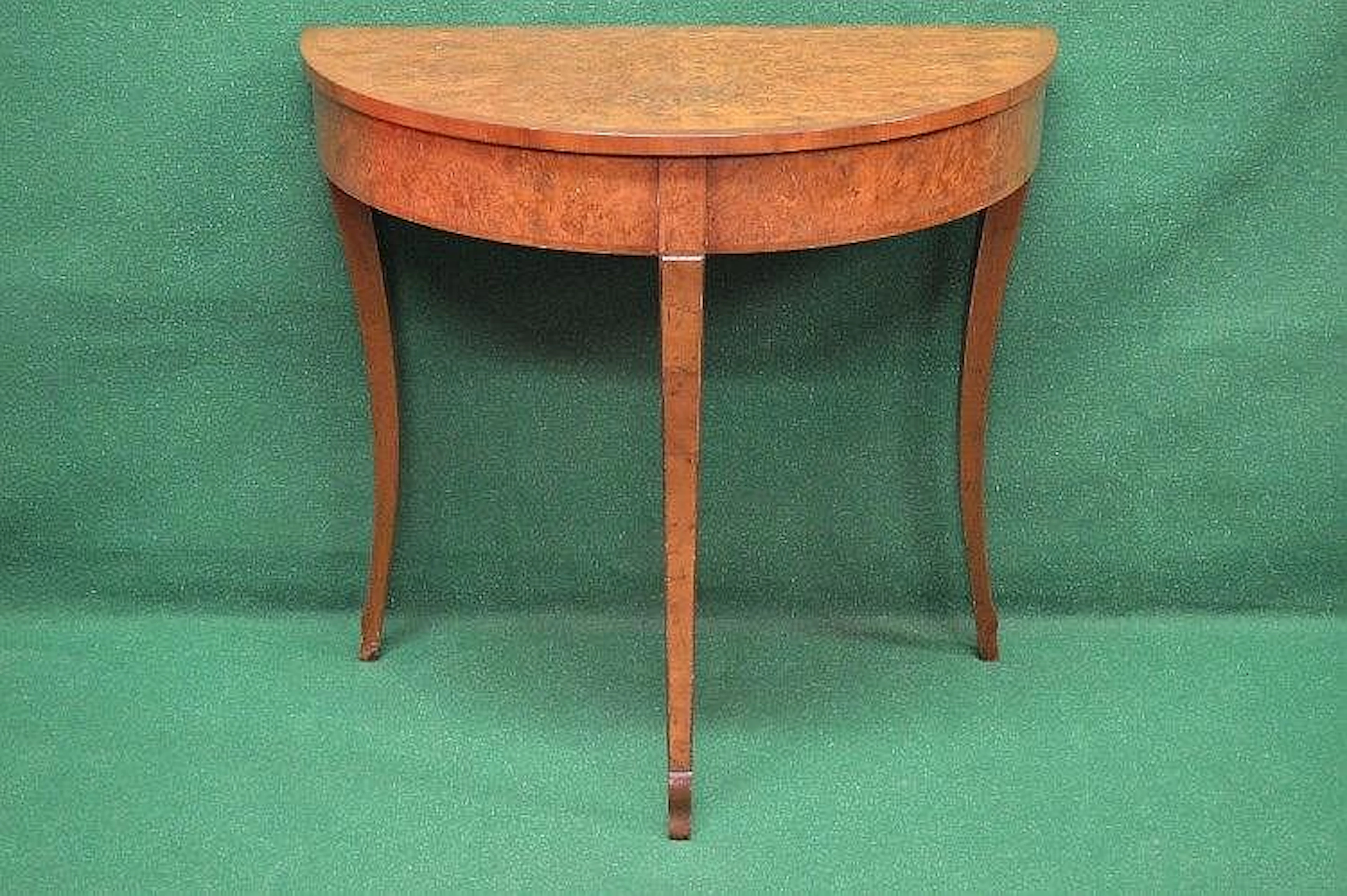 A 20th century walnut cross banded demi lune side table...