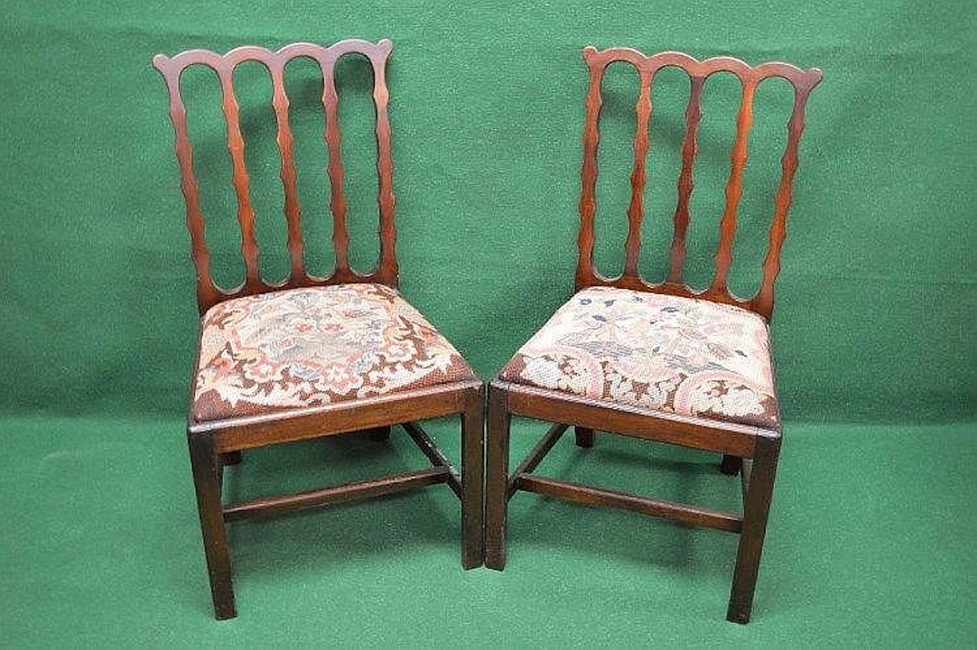 A pair of Chippendale mahogany dining chairs having...