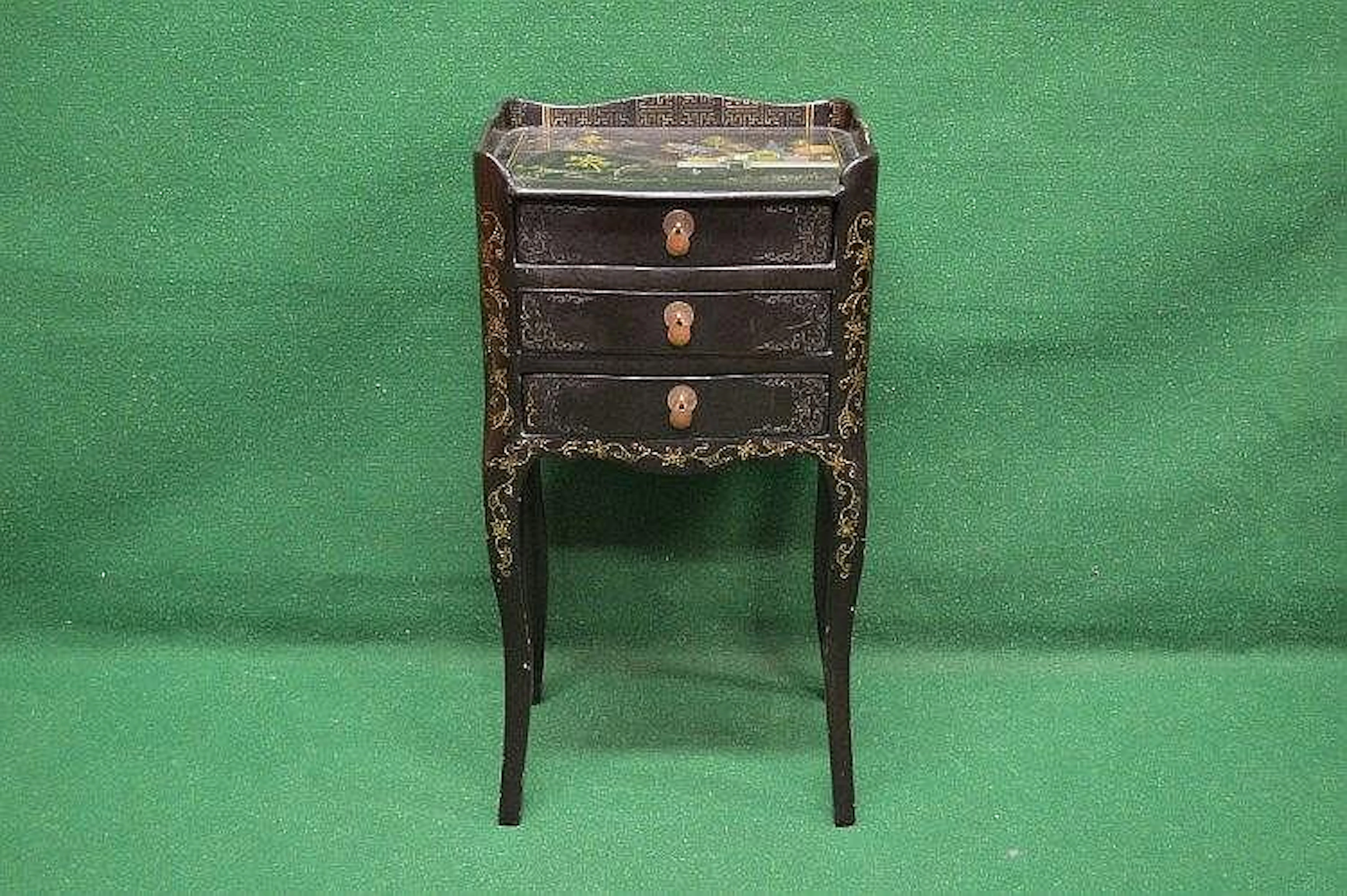 A black lacquered night stand having 3/4 raised gallery...