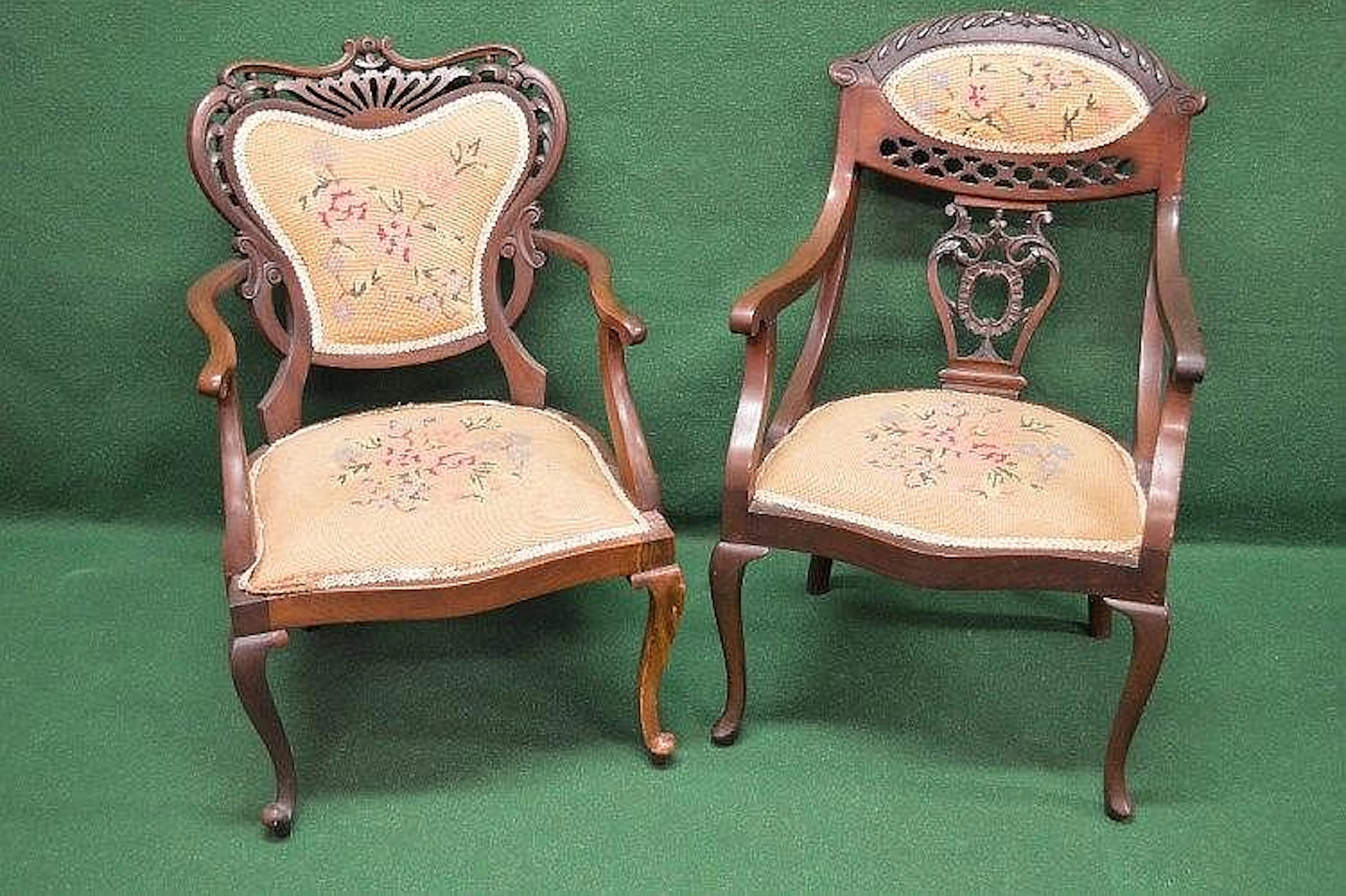 Two mahogany framed open armchairs having tapestry padded backs