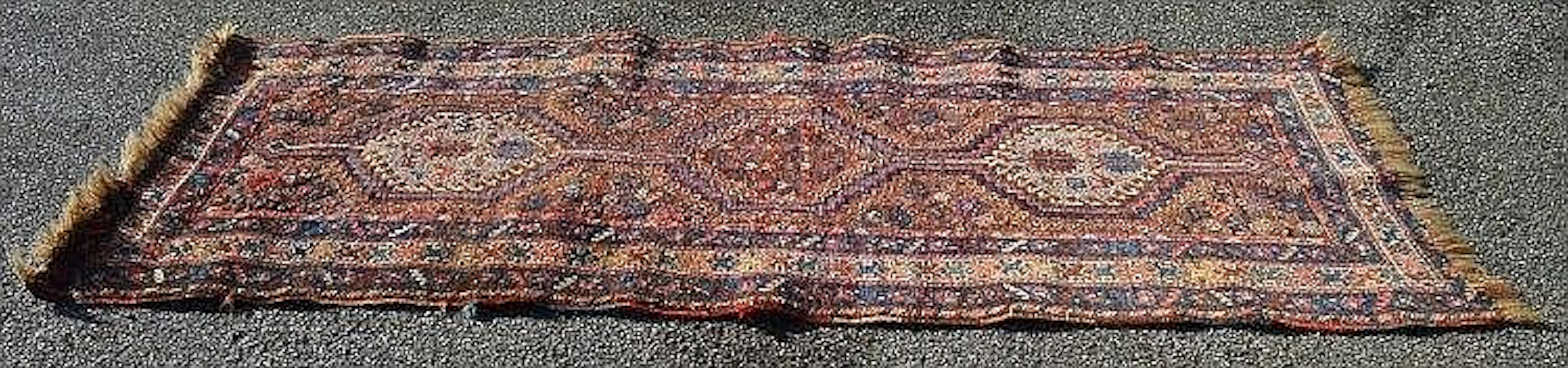 Rust ground rug with red, blue and cream pattern - 96'' x 41.5''