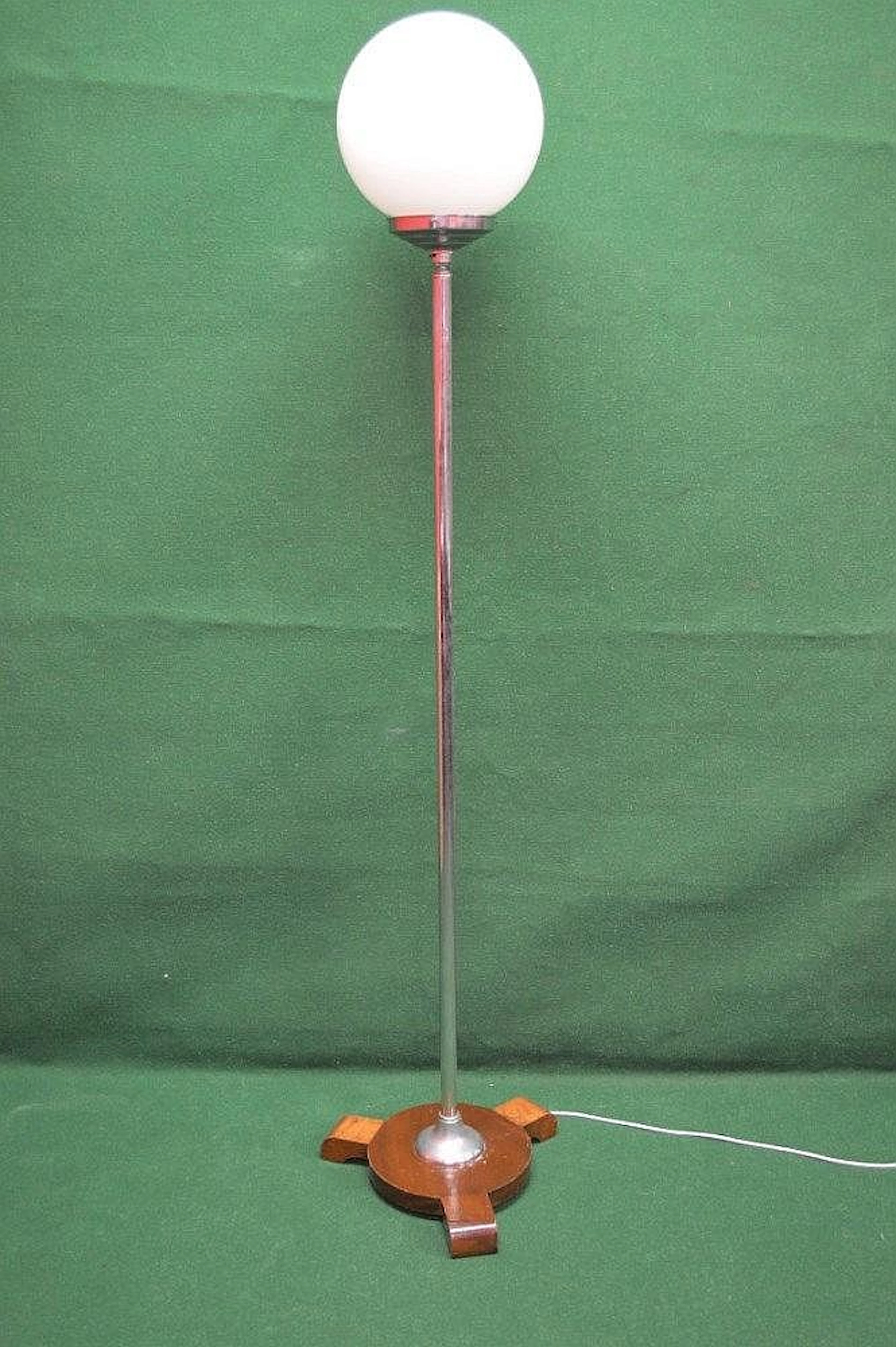 Art Deco standard lamp having white globe shade on a...