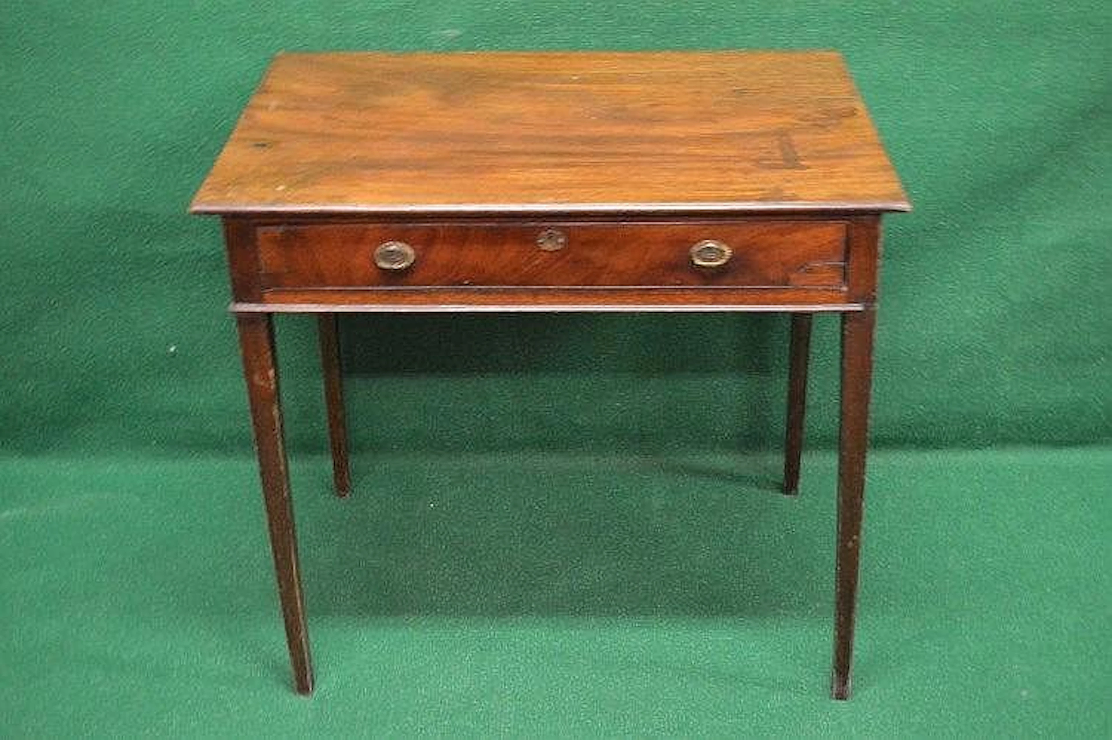 A Georgian mahogany single drawer side table having brass handles and escutcheon