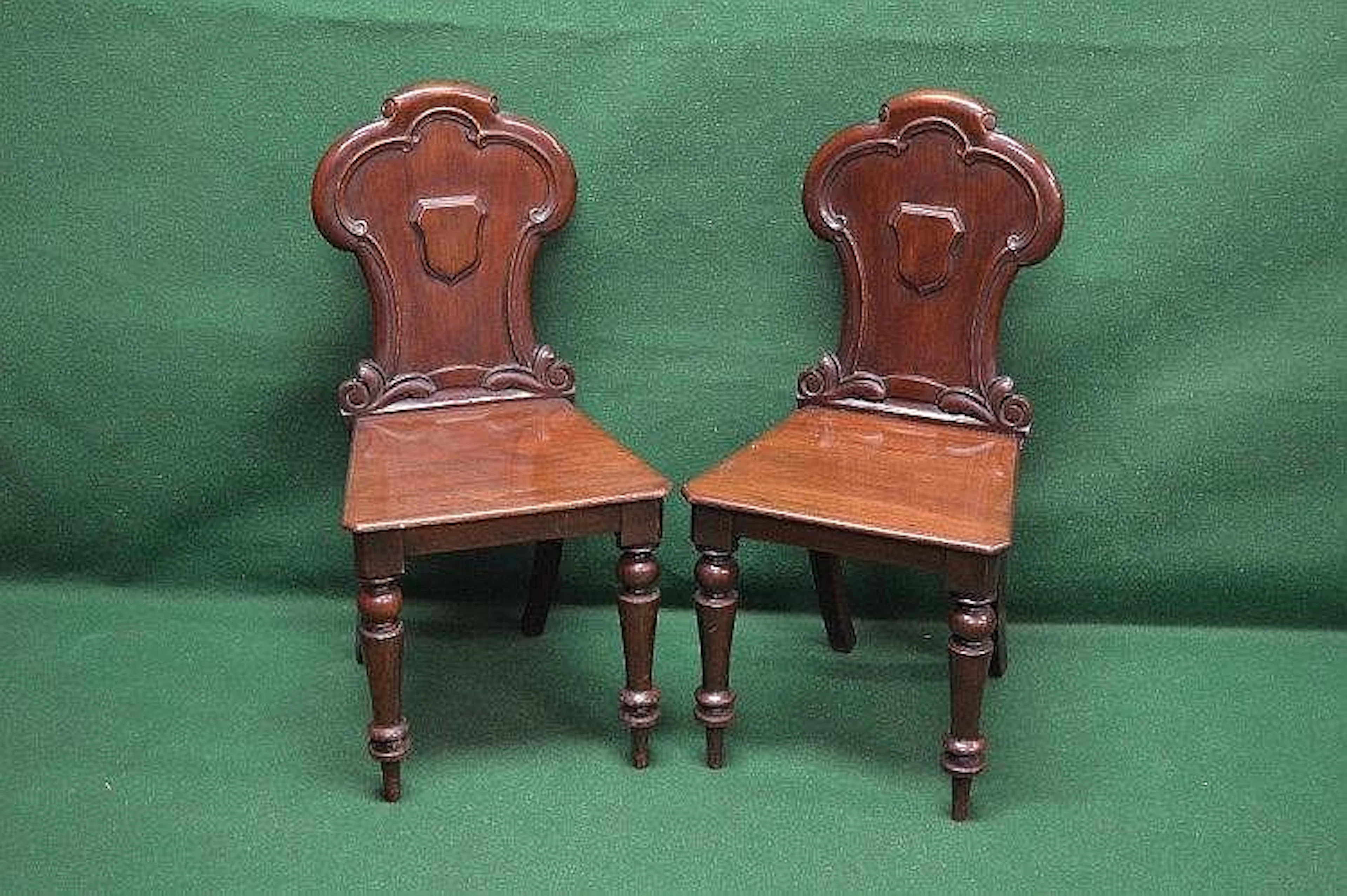 Pair of Victorian hall chairs with solid shaped backs and...