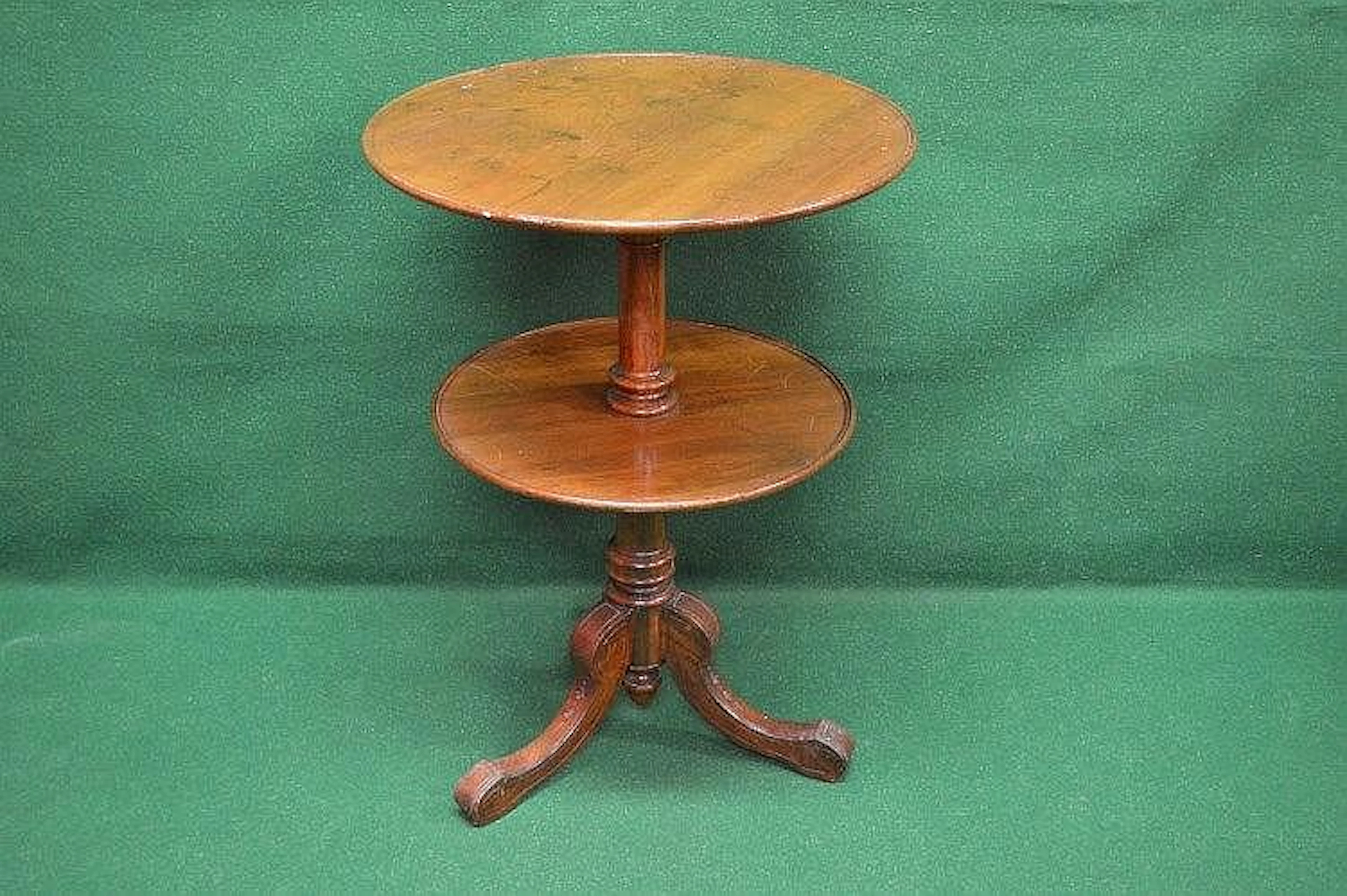 A mahogany two tier dumb waiter the top tier being 24''...