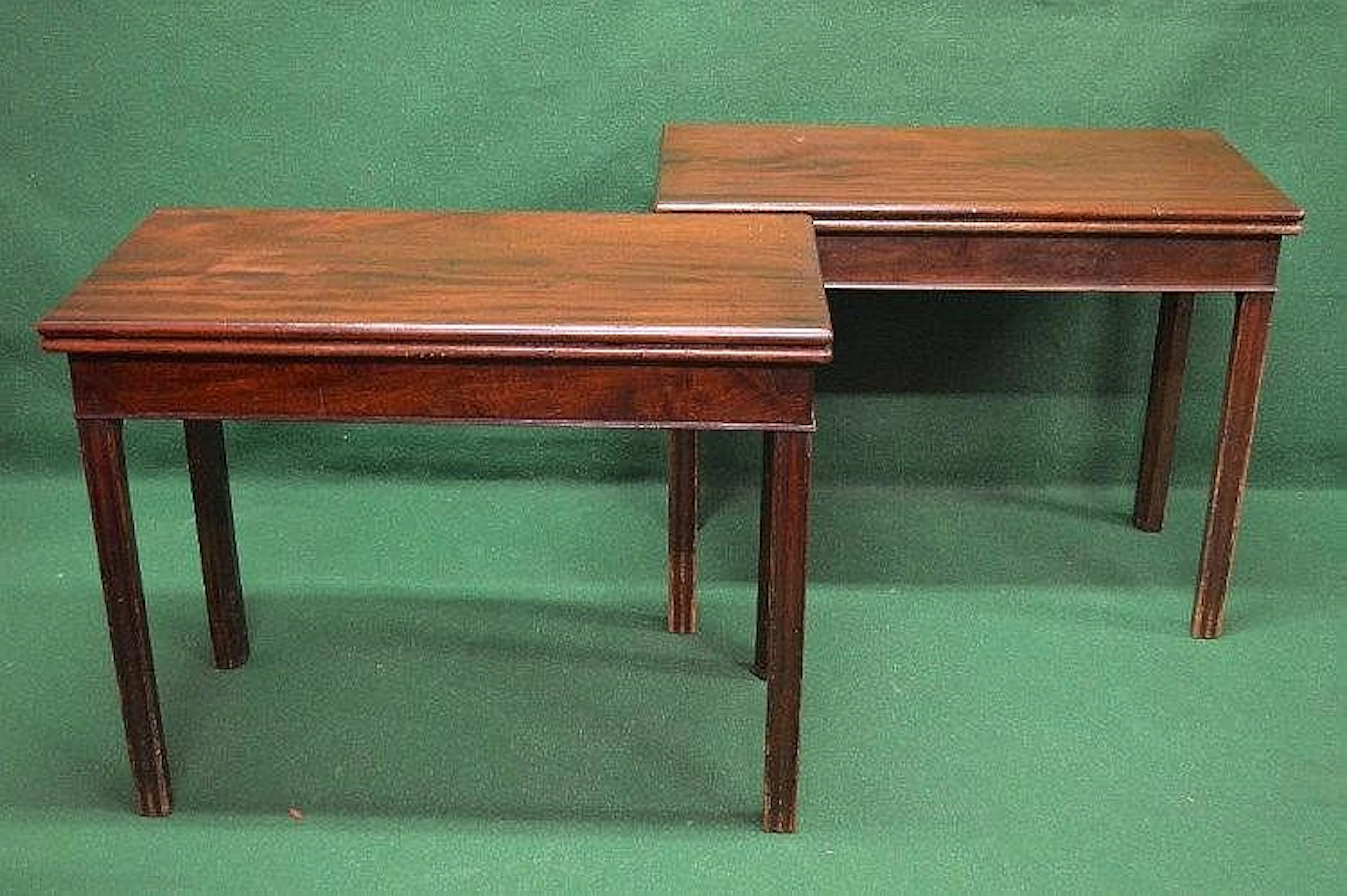 A pair of Georgian mahogany card tables having fold over...