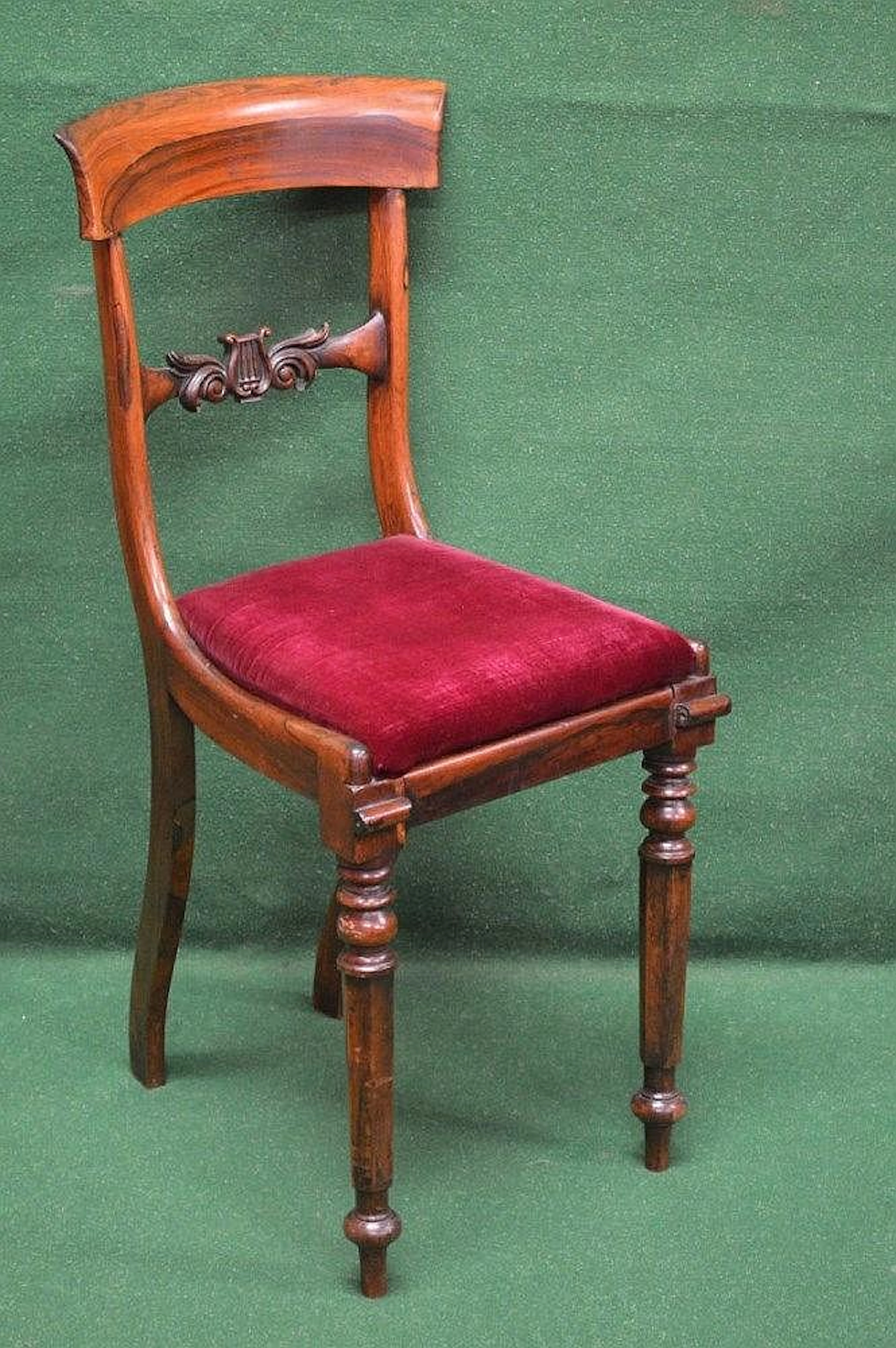 A rosewood cellists chair having curved top rail and...