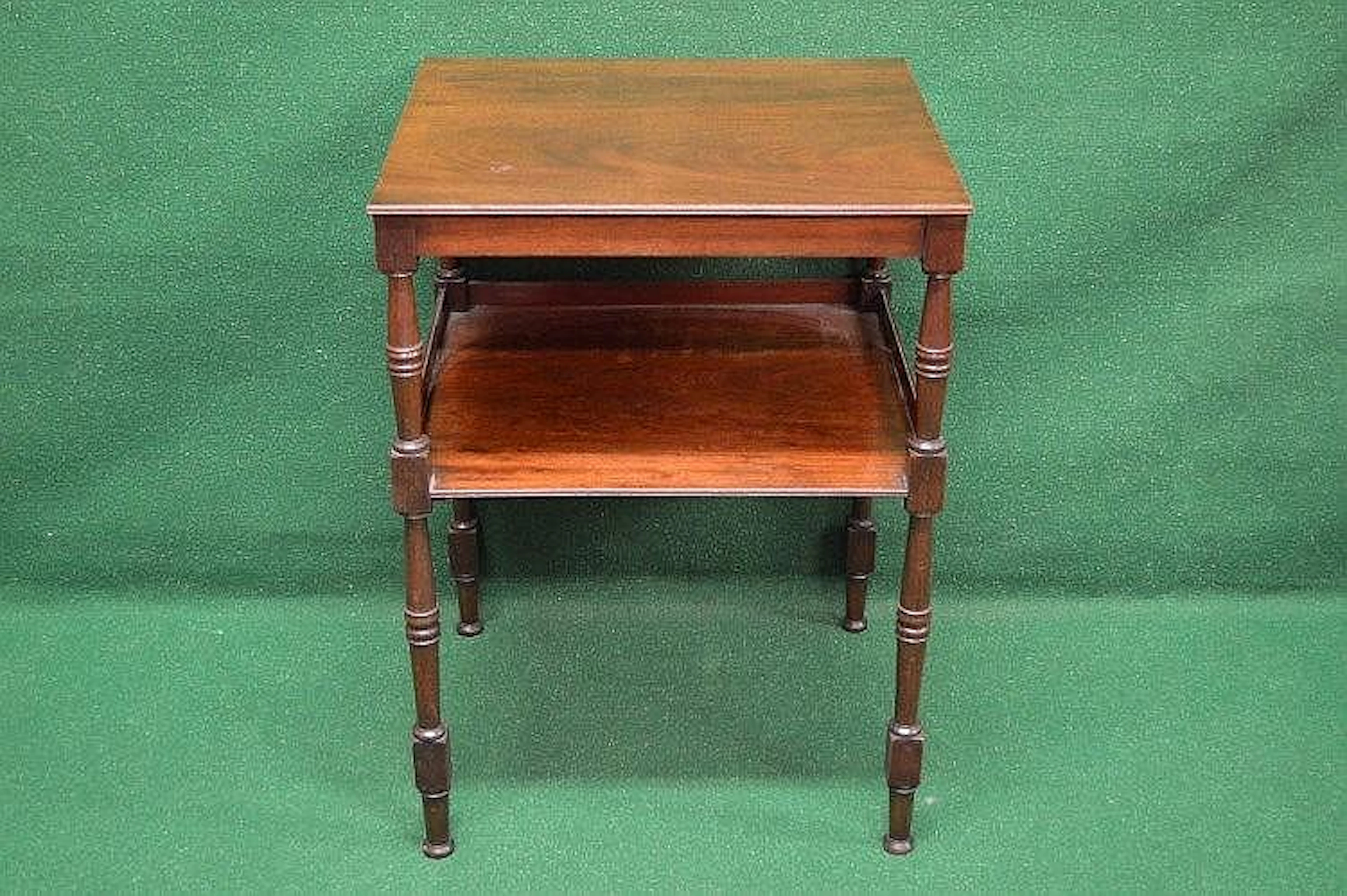 A mahogany two tier occasional table the top having...