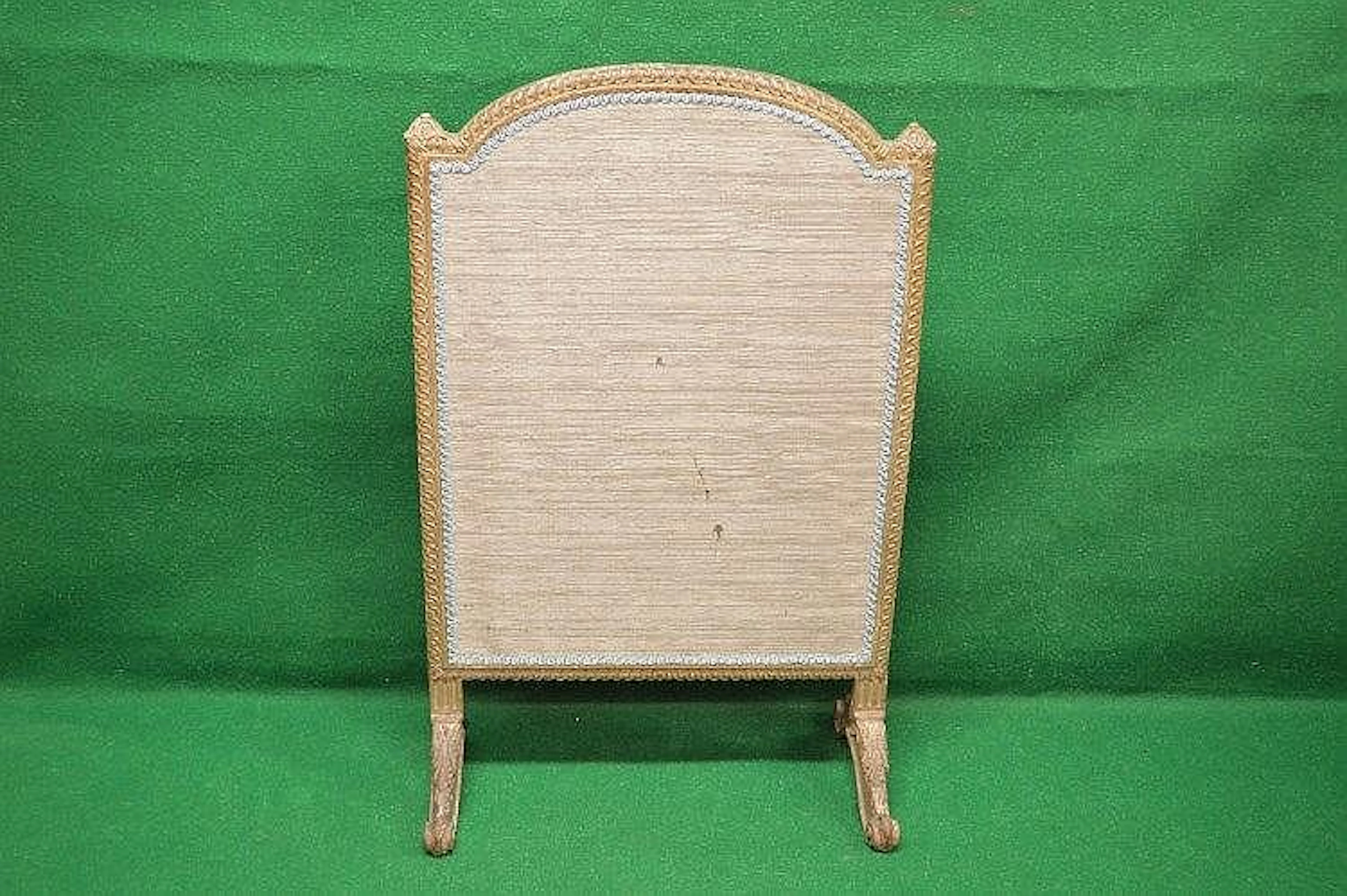 A carved framed fire screen having arched top supported...