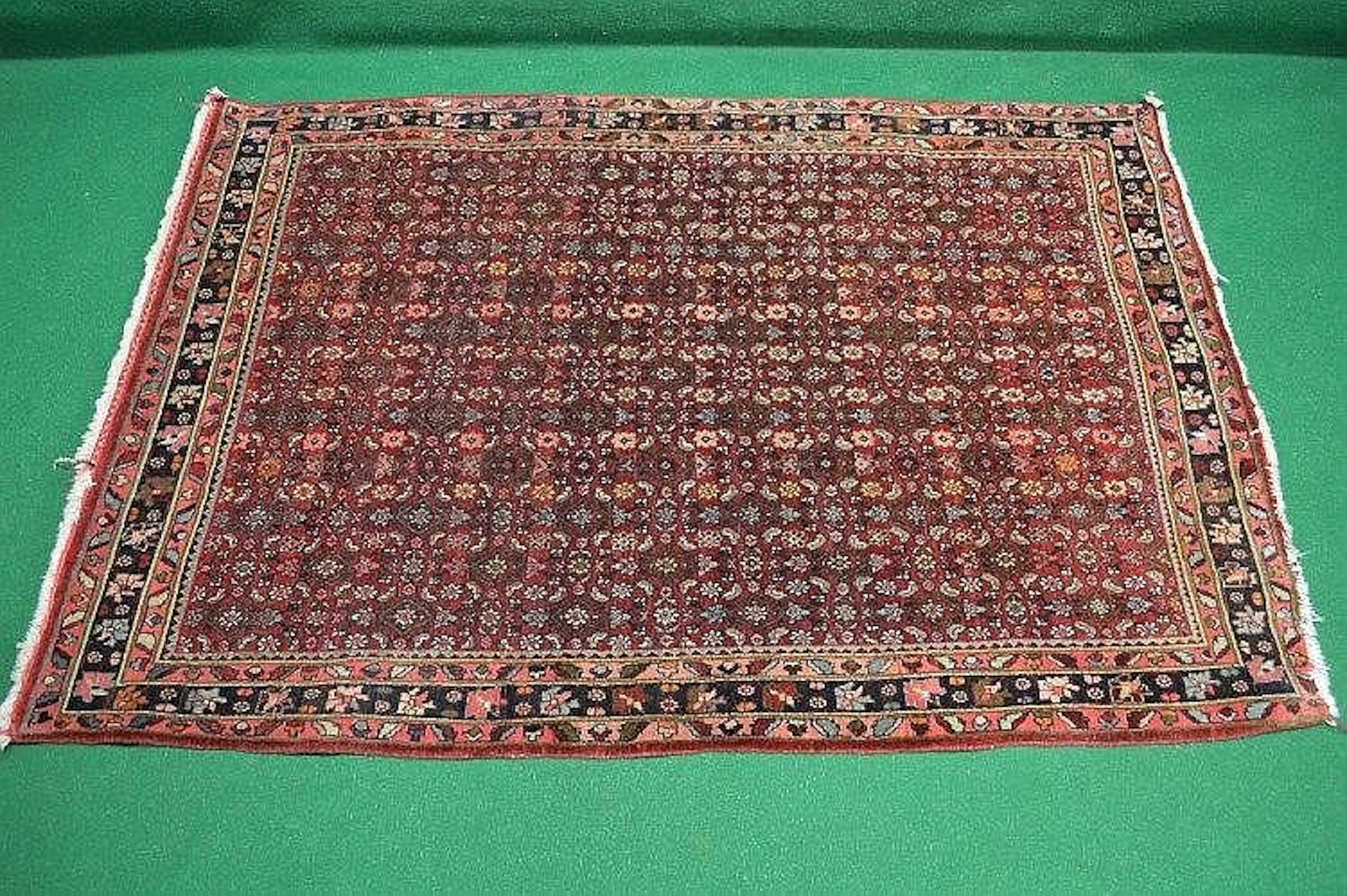 A red ground rug with blue, black and orange pattern - 64.5'' x 44.5''