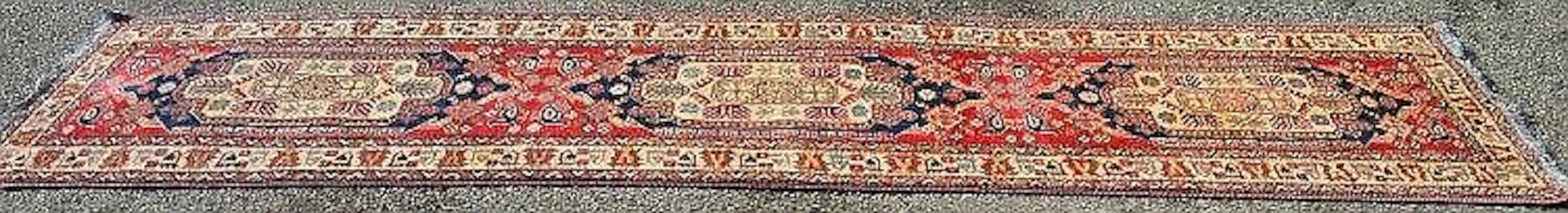 Red and cream ground carpet runner with blue