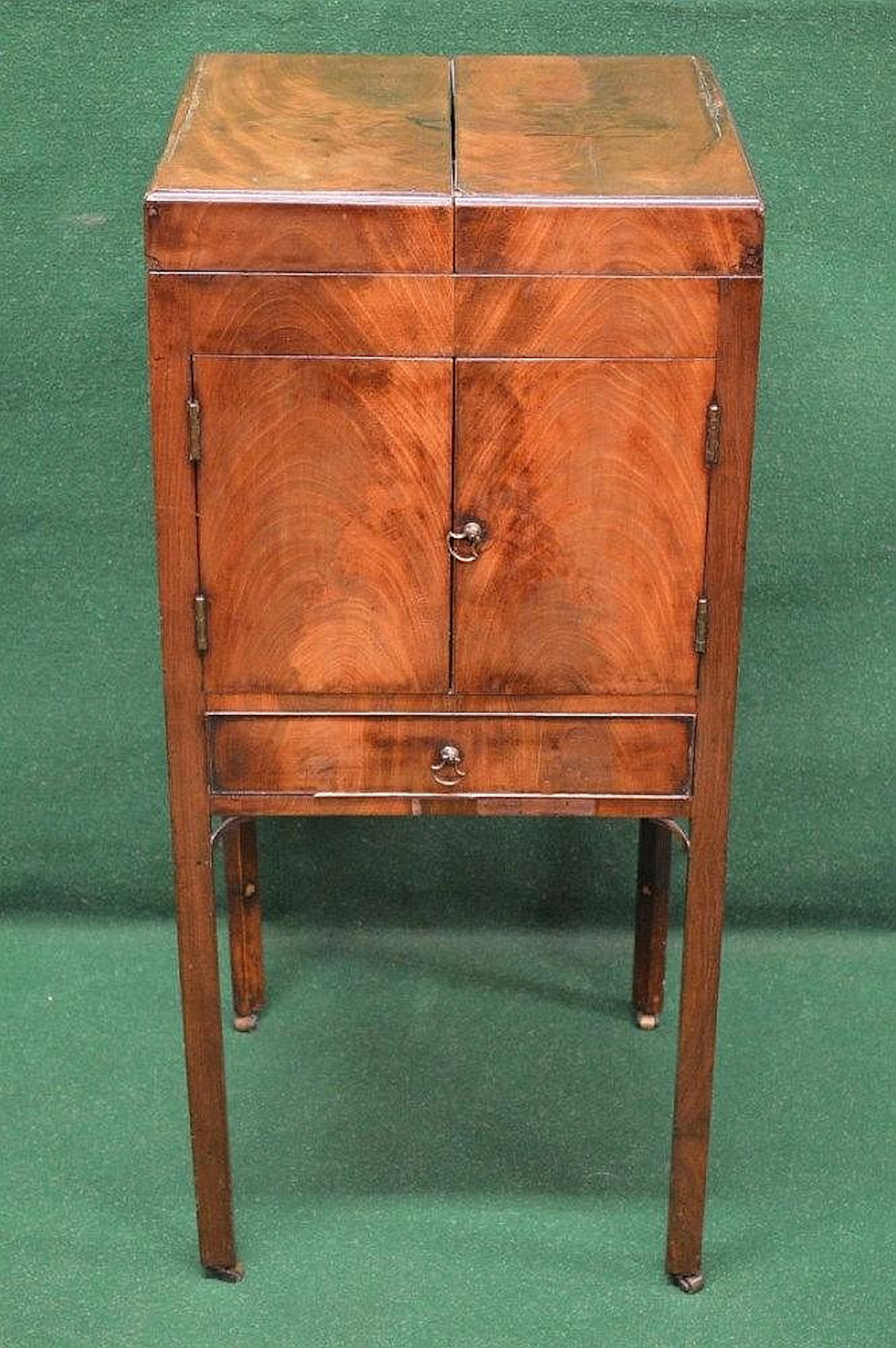 A Georgian mahogany night/washstand the top opening to...