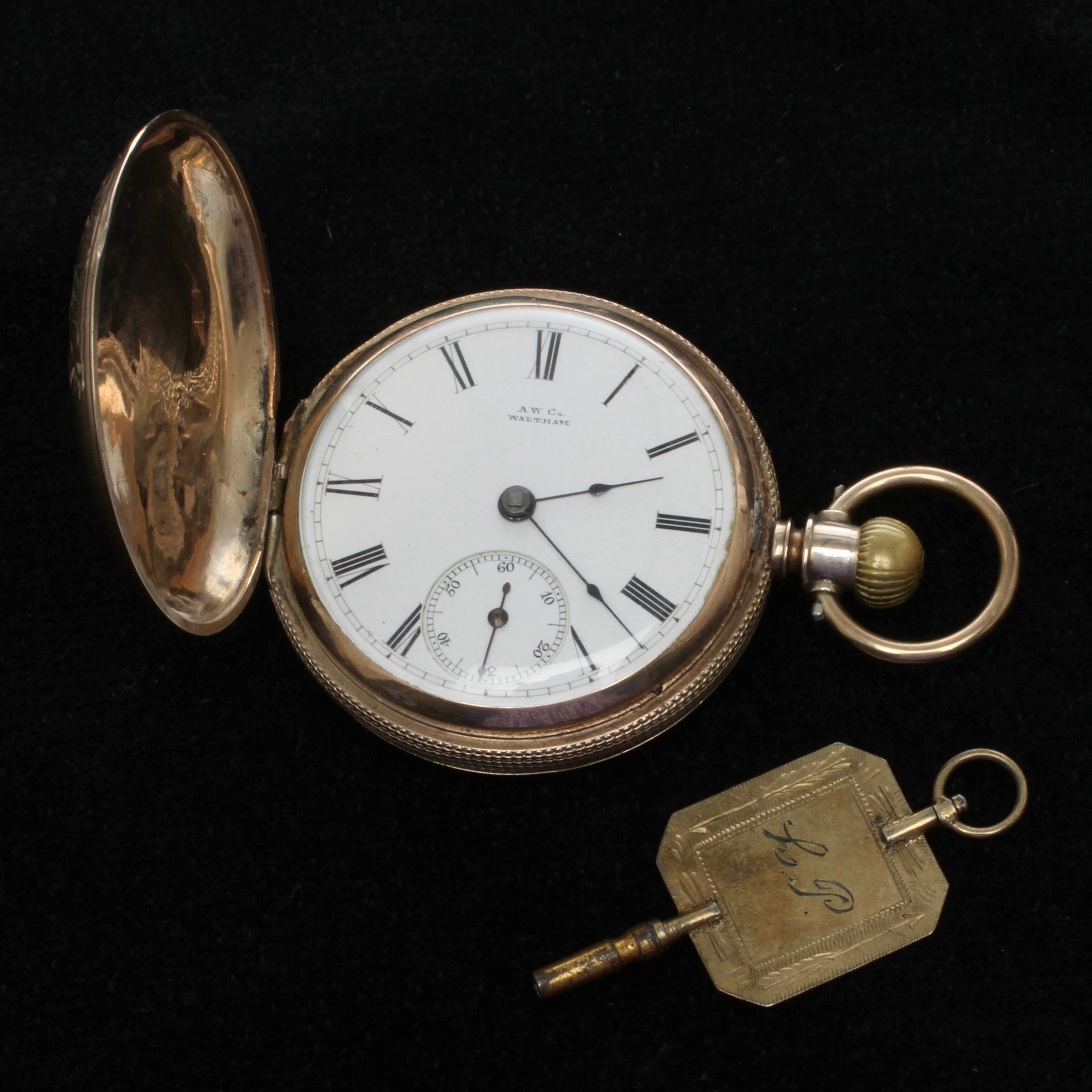 FICKUR, A. W. Co Waltham Wm Ellery, nyckeldragare, boett i lågkaratigt guld samt NYCKEL, delvis silver. 1800-tal.