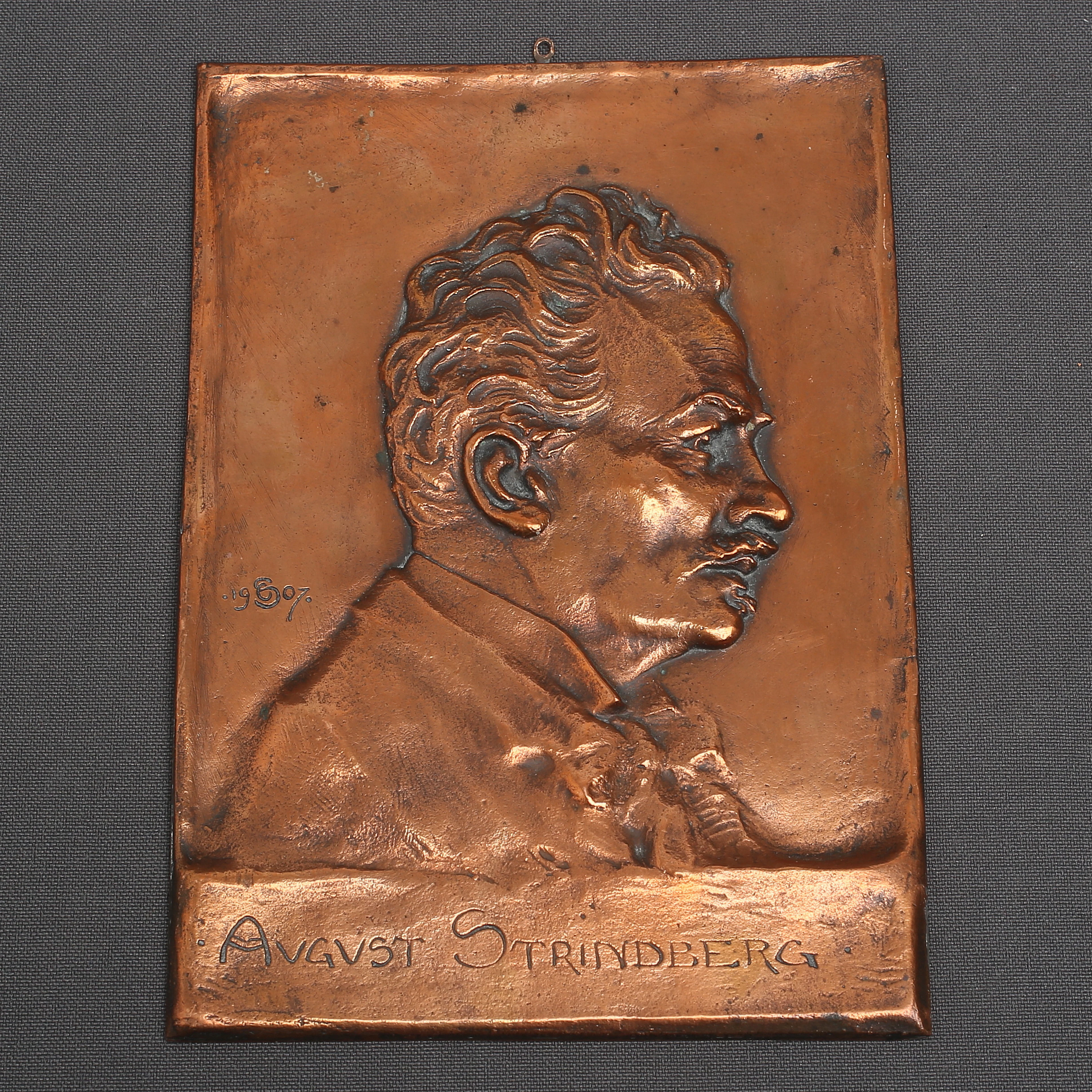 OTTO STRANDMAN. Relief, koppar, föreställande August Strindberg, monogramignatur och datering 1907 i plåten.