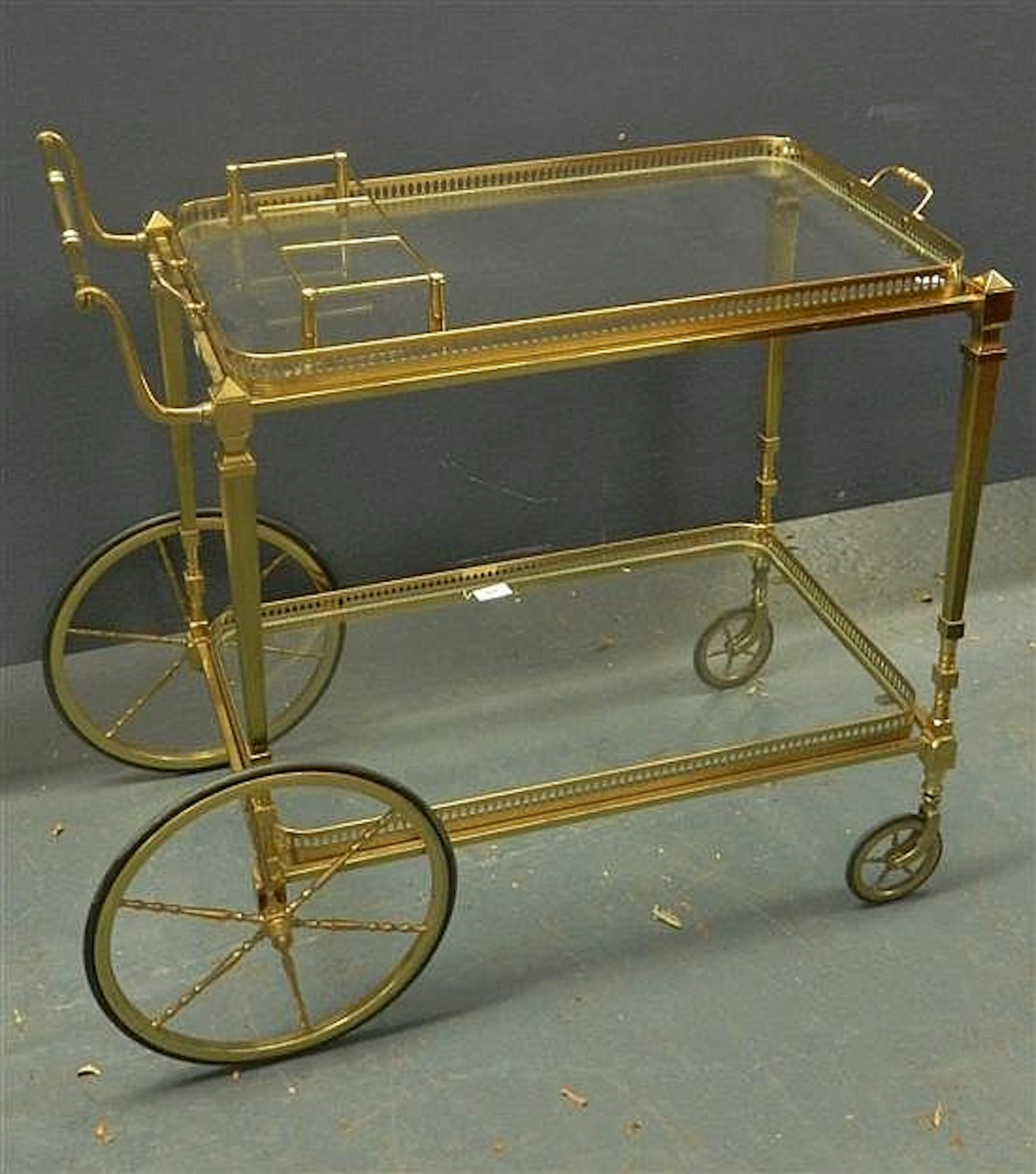 A C1970 Brass Drinks Trolley, the glass shelf with brass bottle holder