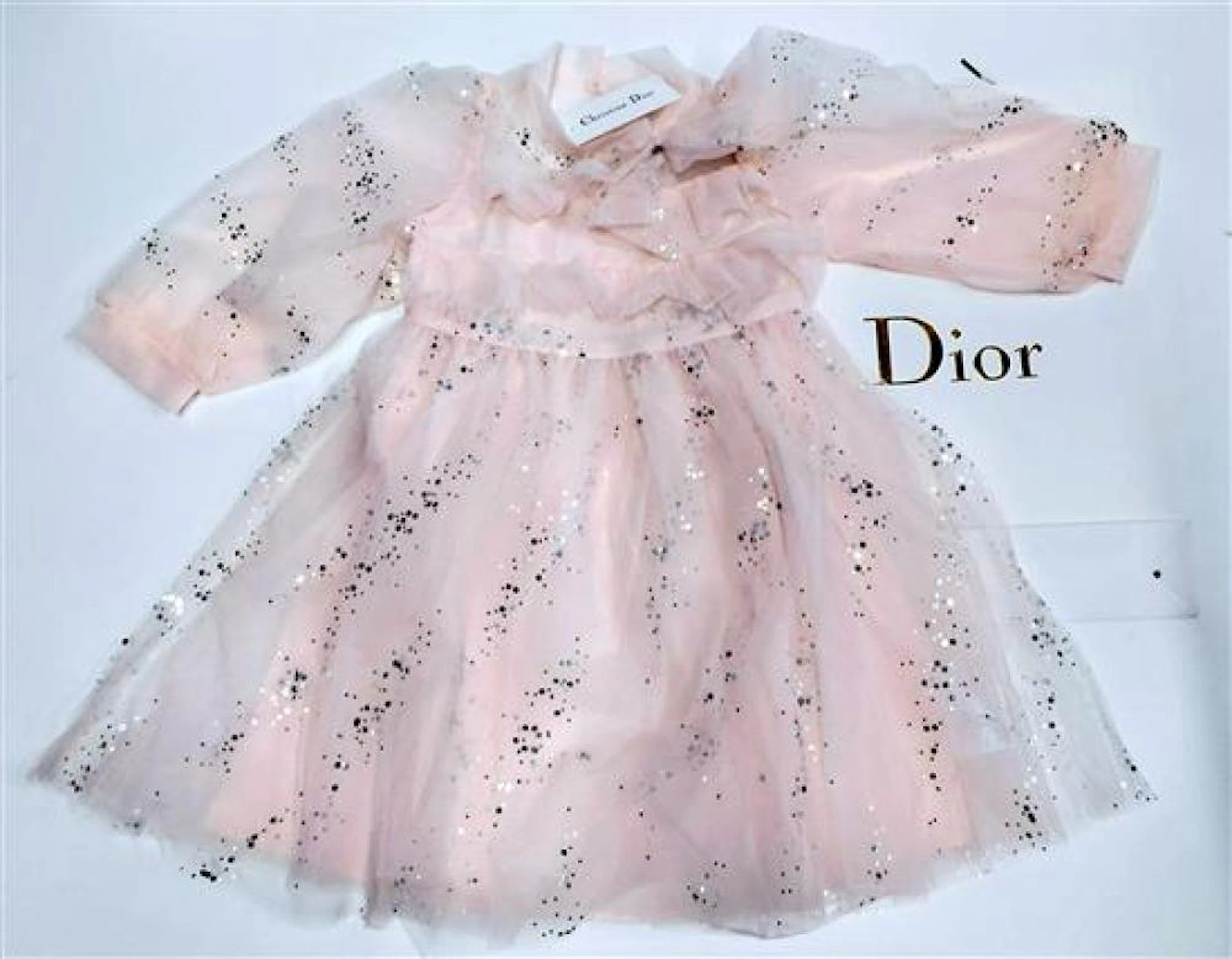 A designer child's blush pink dress marked Christian Dior size 110