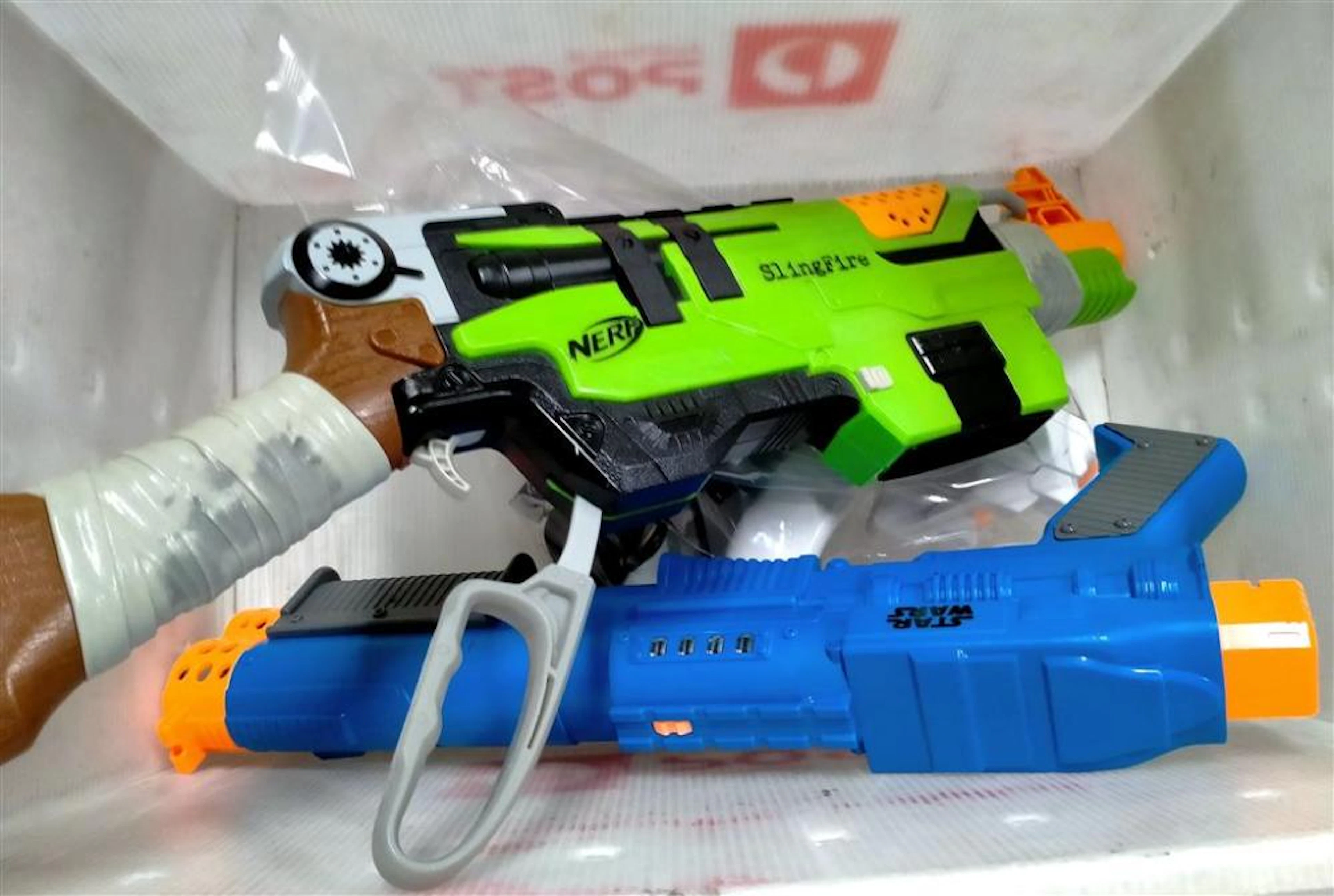 A box of toy guns incl. Nerf & Star Wars