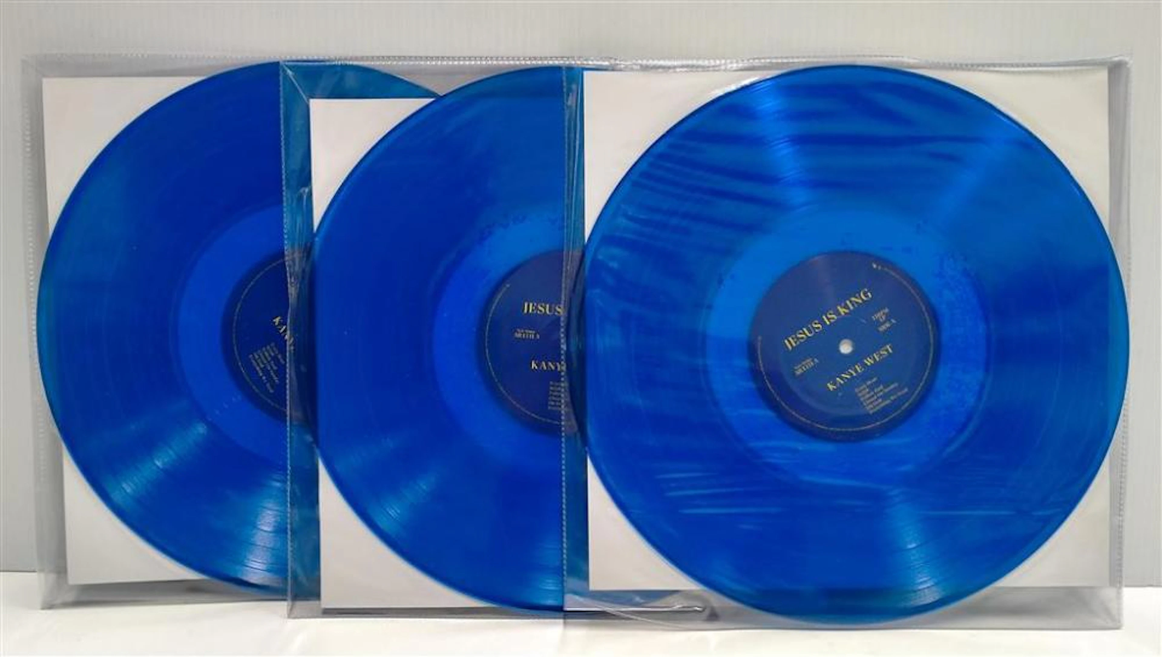 Three blue records marked Jesus Is King by Kanye West