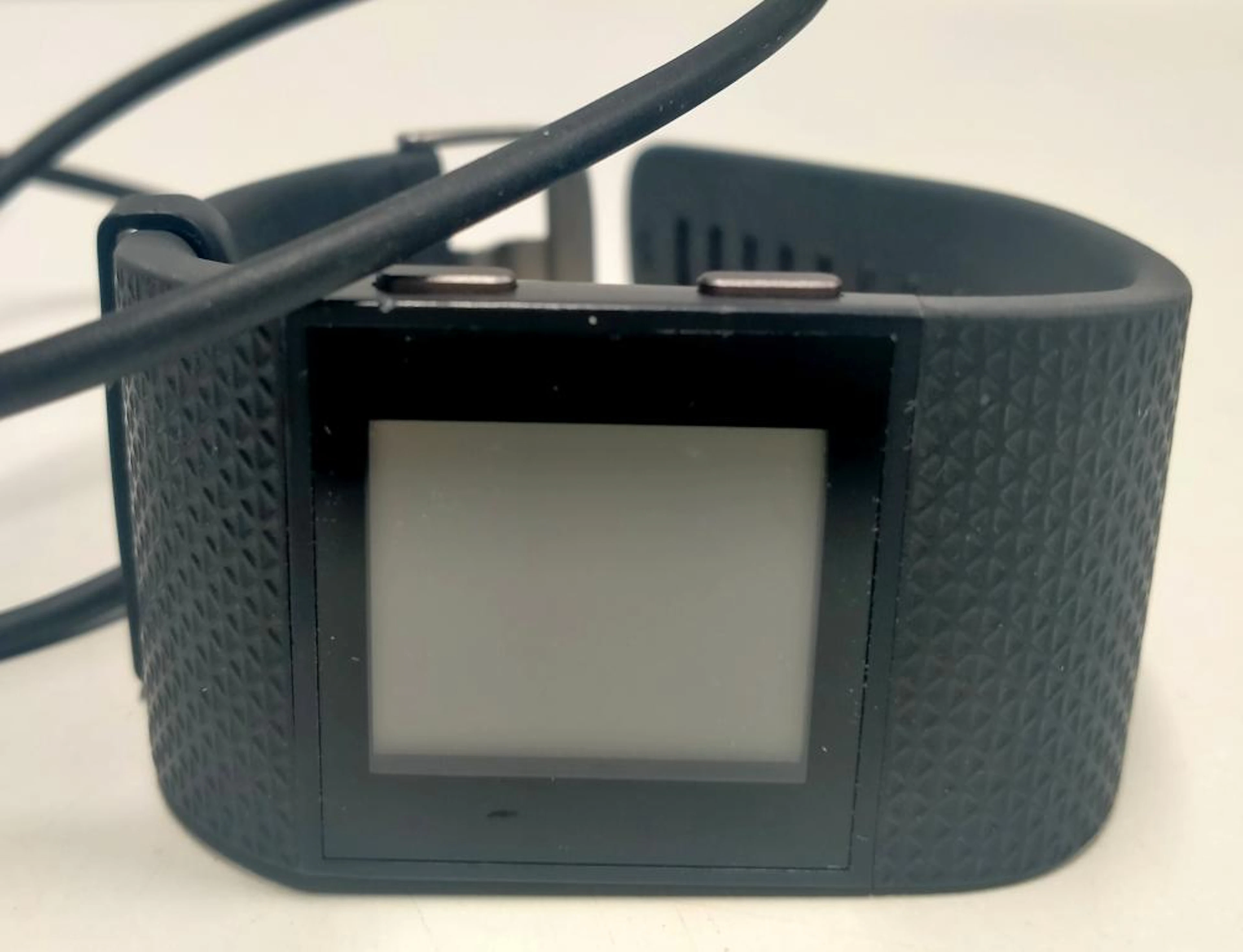A smart watch marked Fitbit Surge