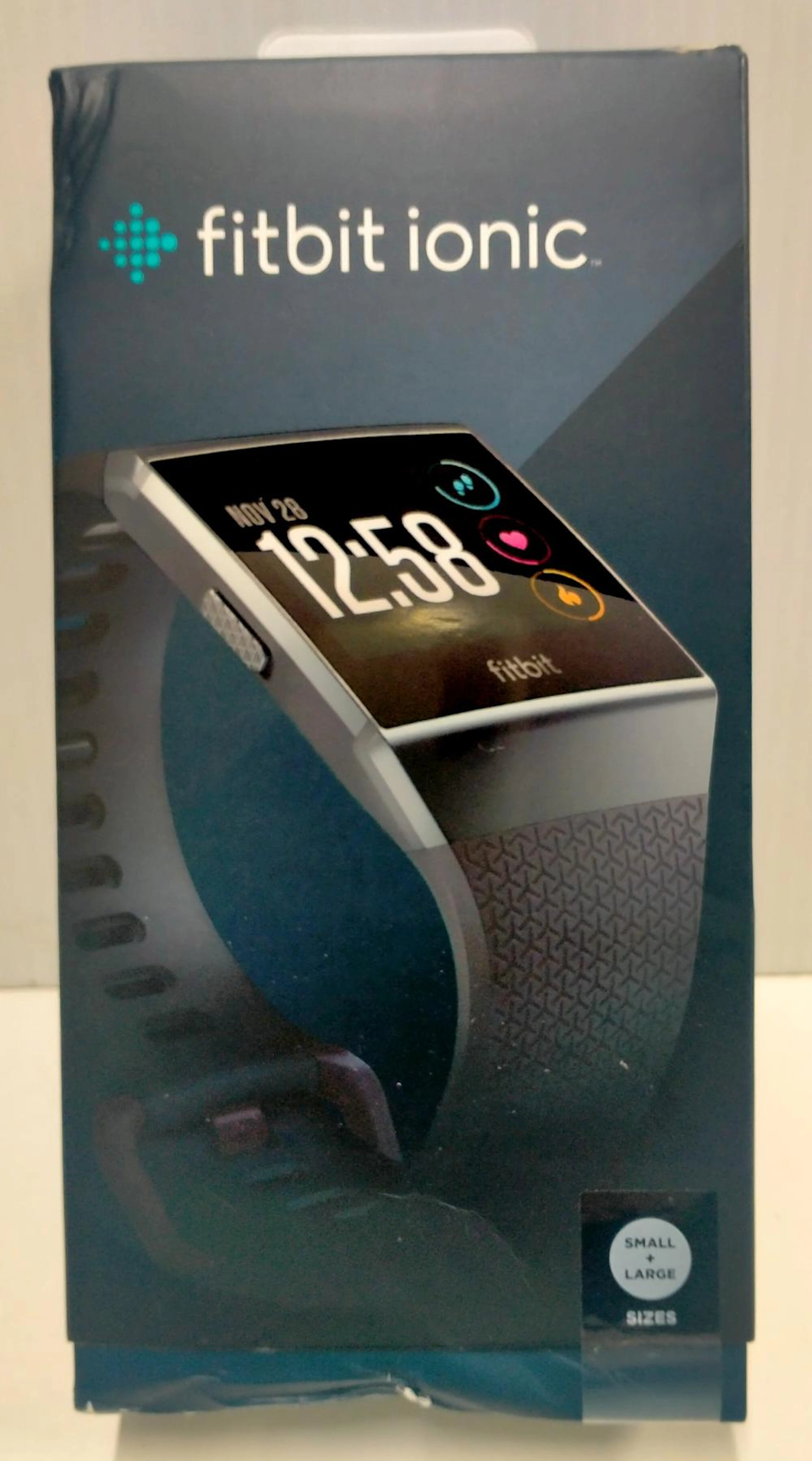 A smart watch marked Fitbit ionic in damaged box