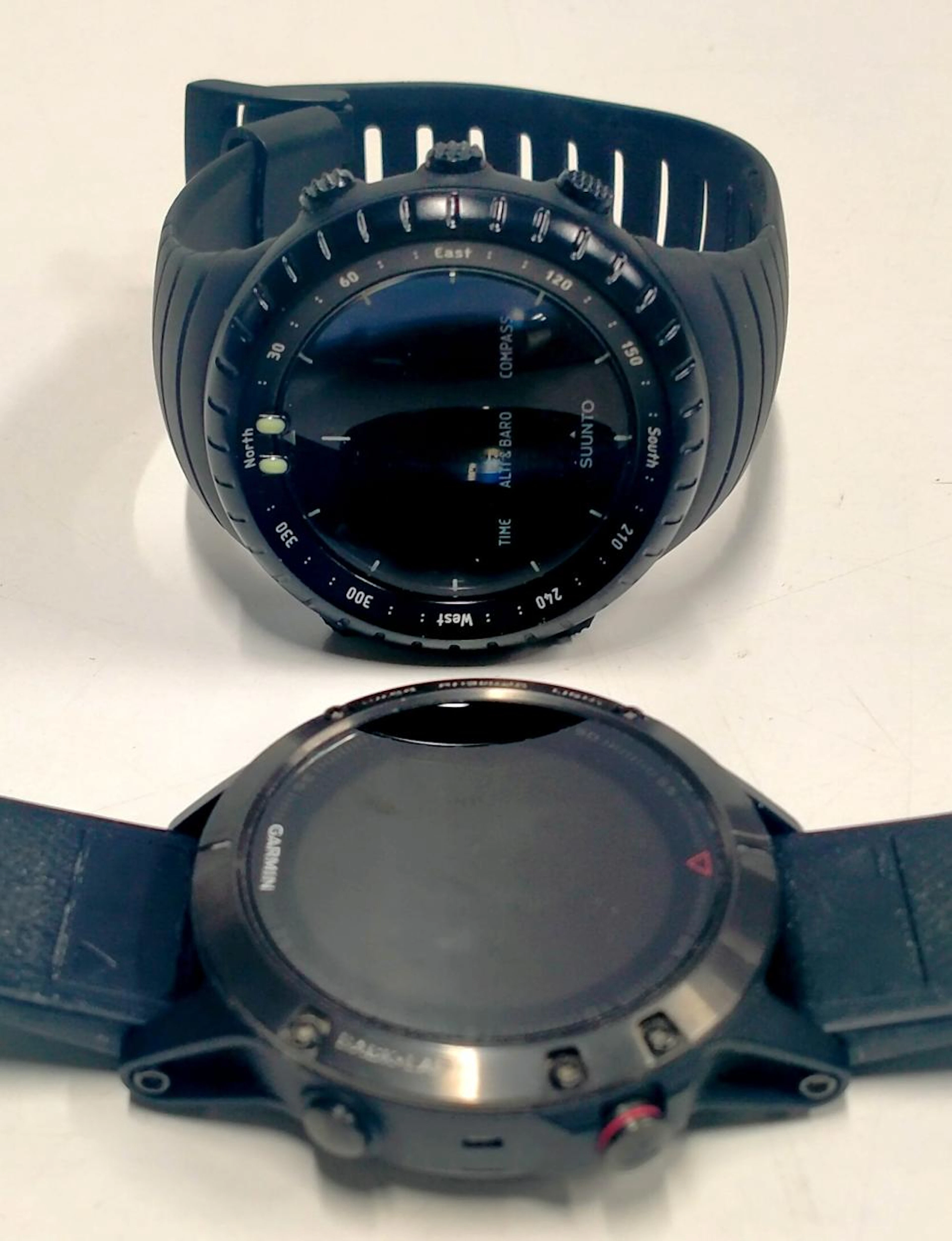 Two 2nd hand smart watches marked Garmin & Suunto Core