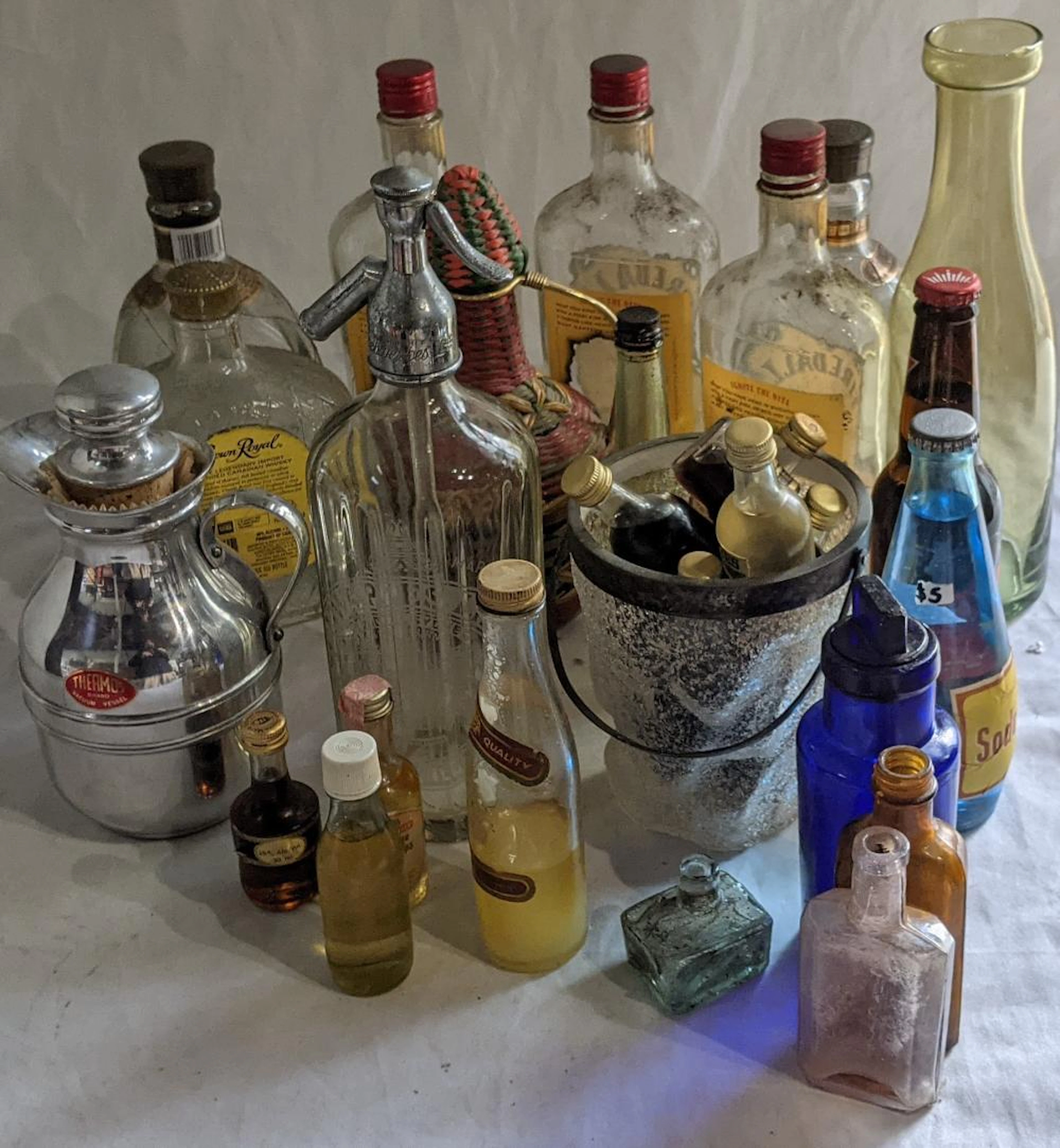 A Collection Of Baranalia & Glass Bottles Including A Schweppes Soda Syphon.