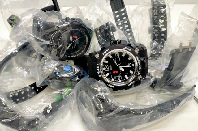 A bag of assorted sports watches marked Smael