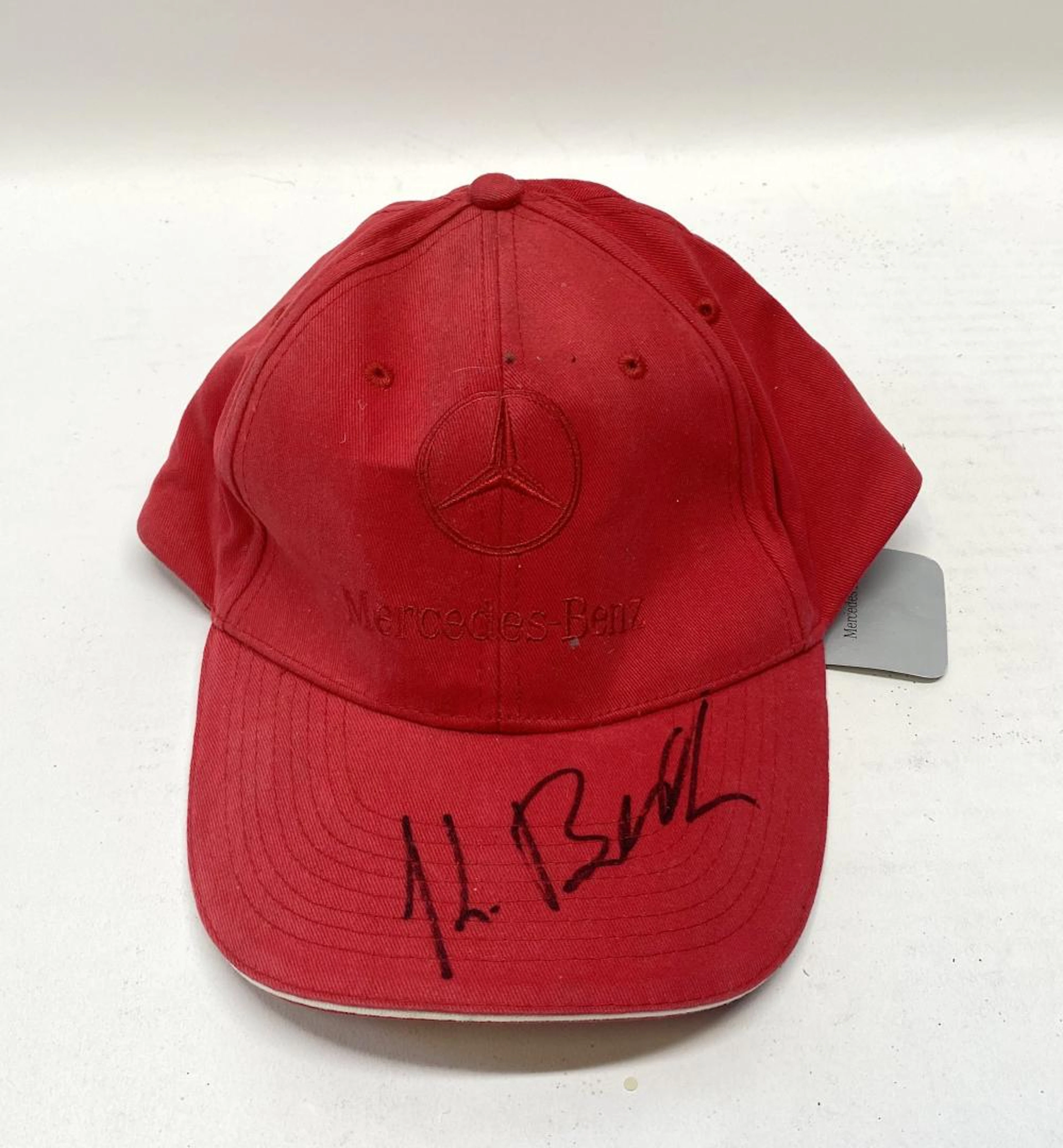 A signed cap marked Mercedes Benz
